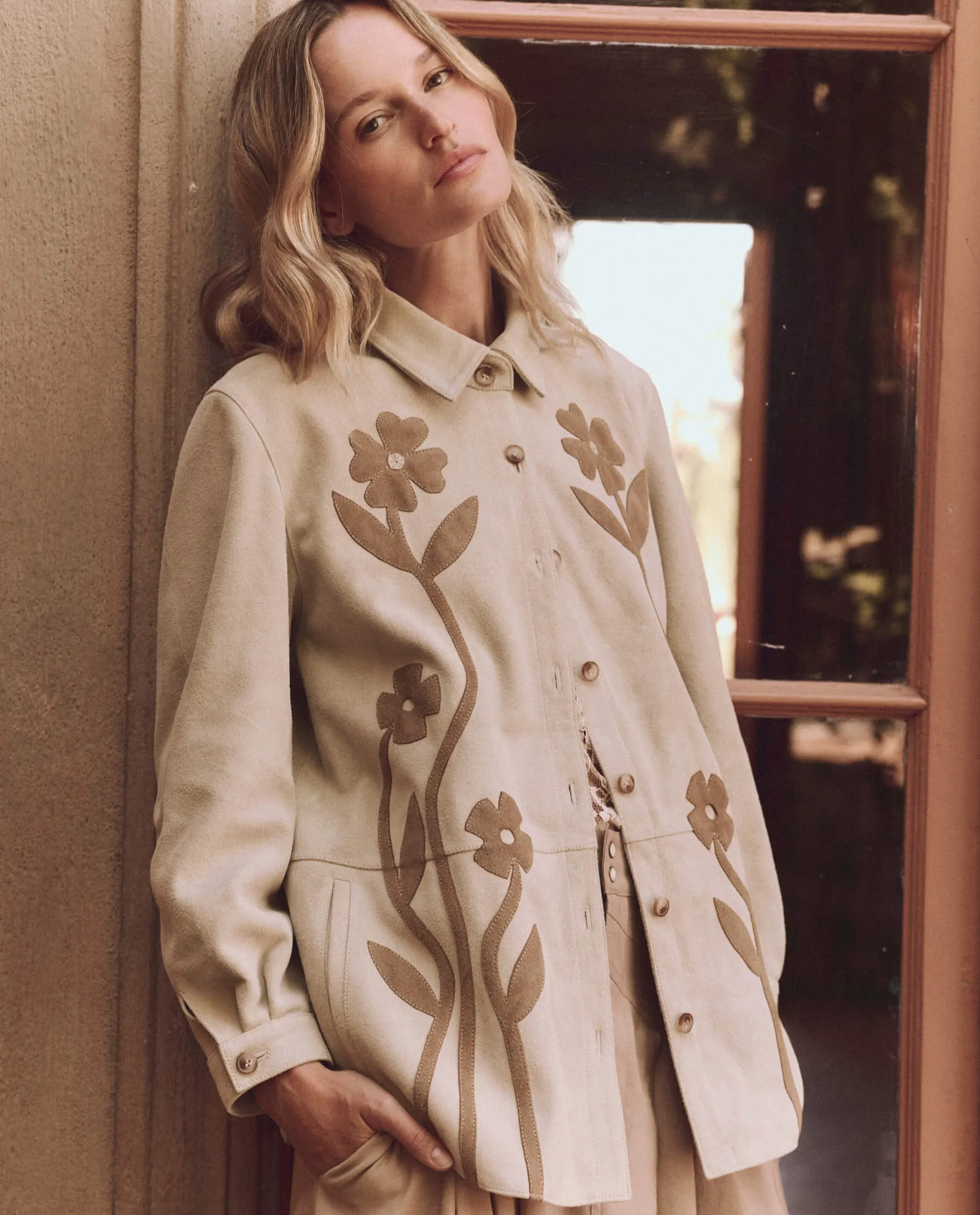 The Floral Applique Suede Jacket. -- Tonal Desert Tan sold by THE GREAT.