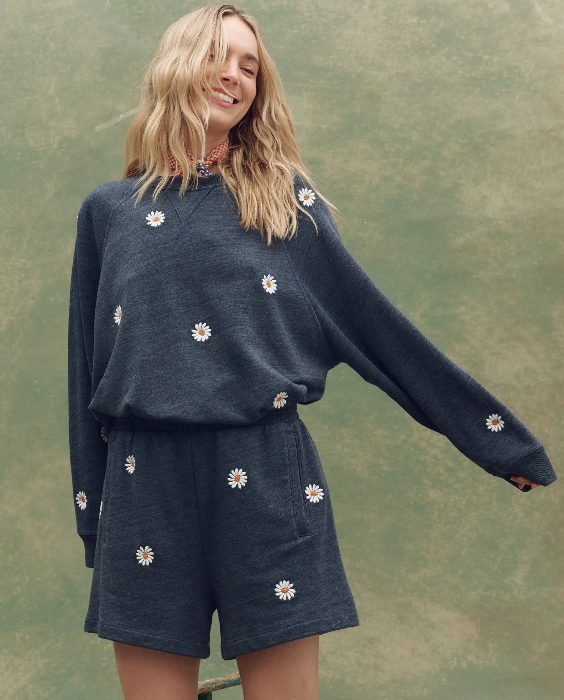 The Slouch Sweatshirt. Embroidered -- Heathered Vintage Blue with Floating Daisy Embroidery sold by THE GREAT.