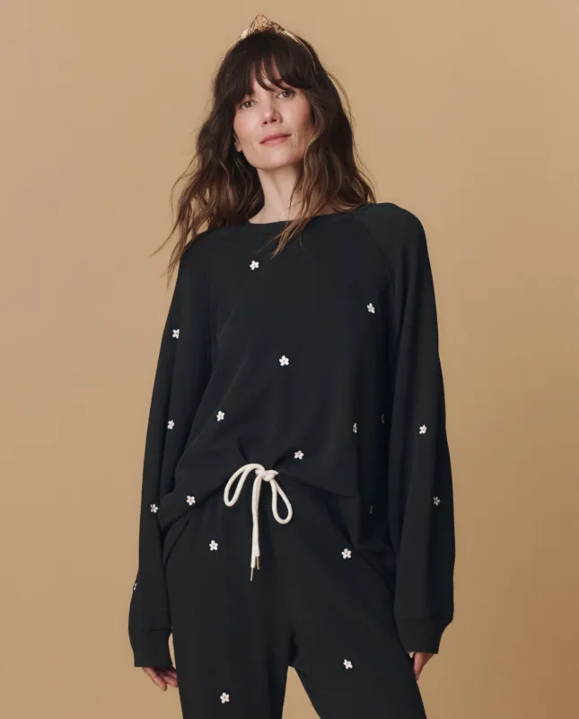 The Slouch Sweatshirt. Embroidered -- Almost Black With Daisy Embroidery sold by THE GREAT.