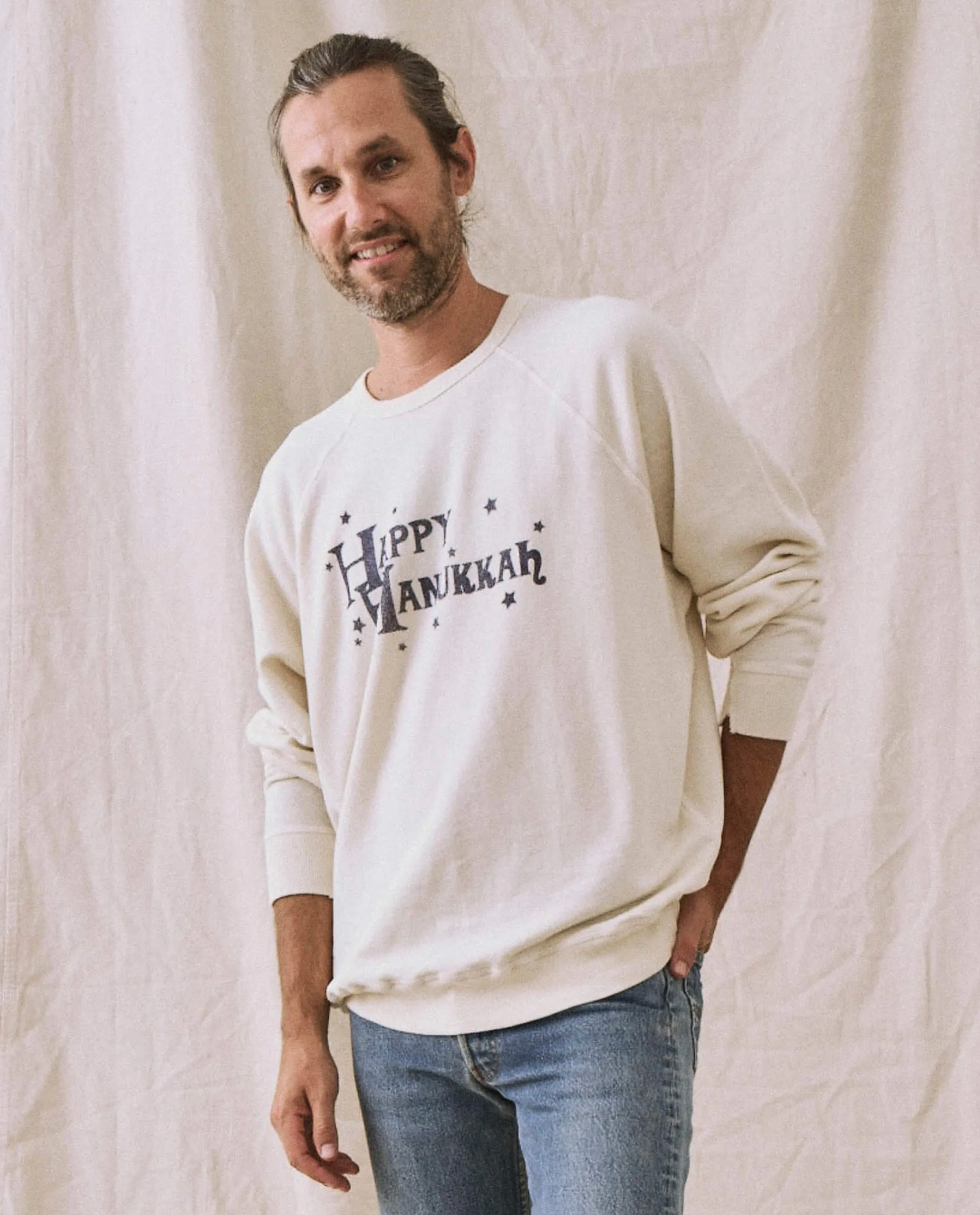 The Men's College Sweatshirt. -- Washed White with Hanukkah Graphic sold by THE GREAT.