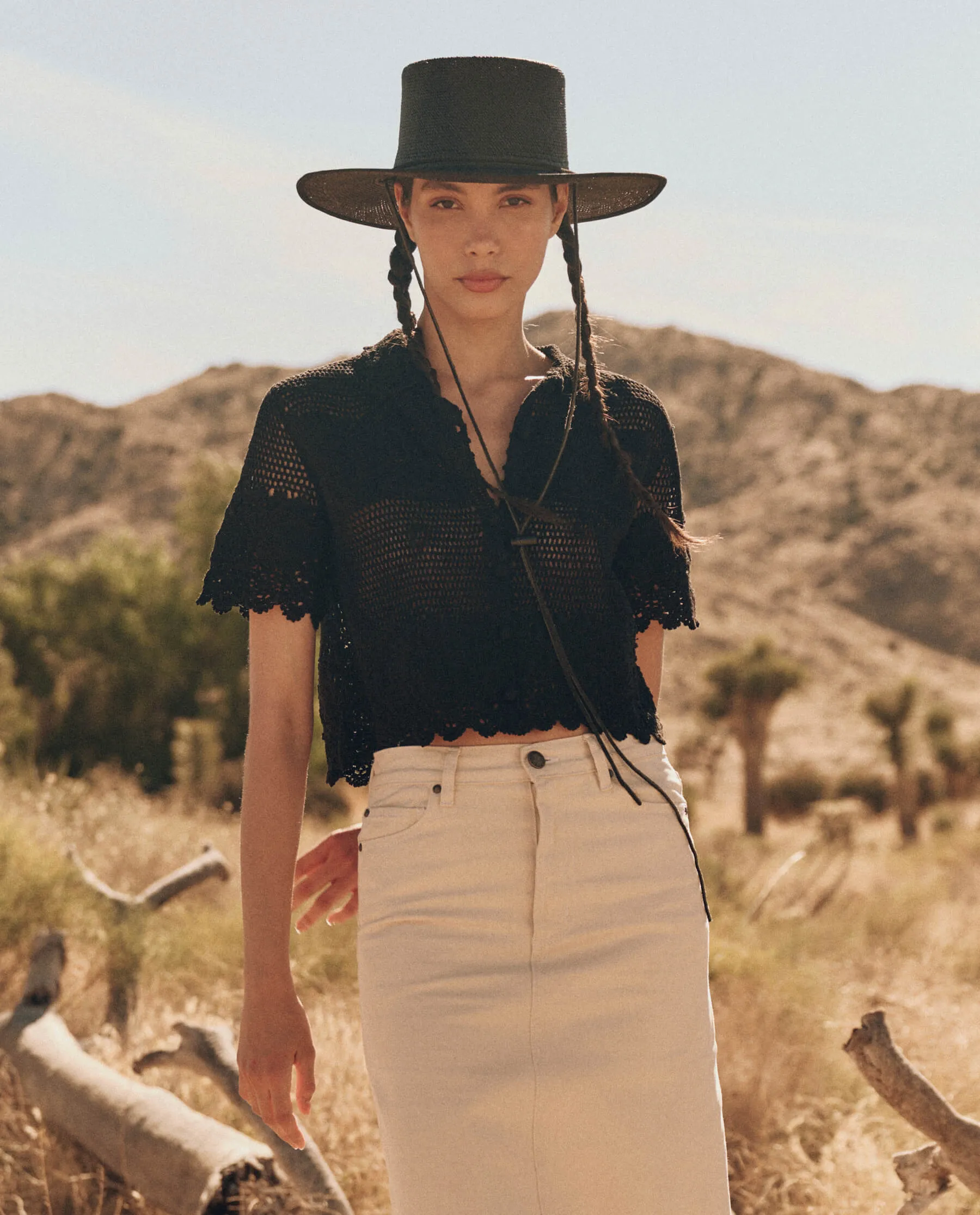 The Crochet Polo Top. -- Black sold by THE GREAT.