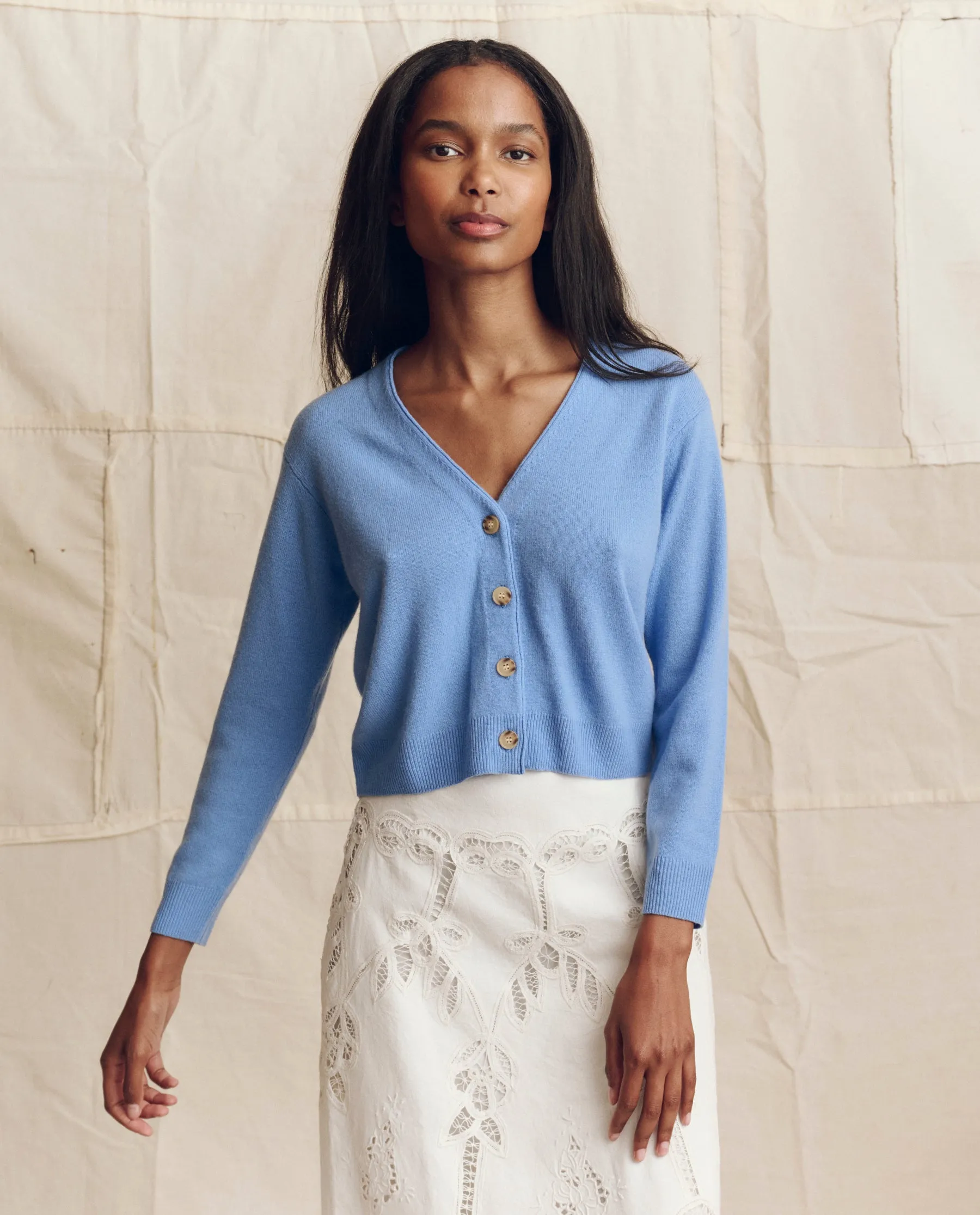 The Cashmere Tiny V Neck Cardigan. -- Soft Blue sold by THE GREAT.