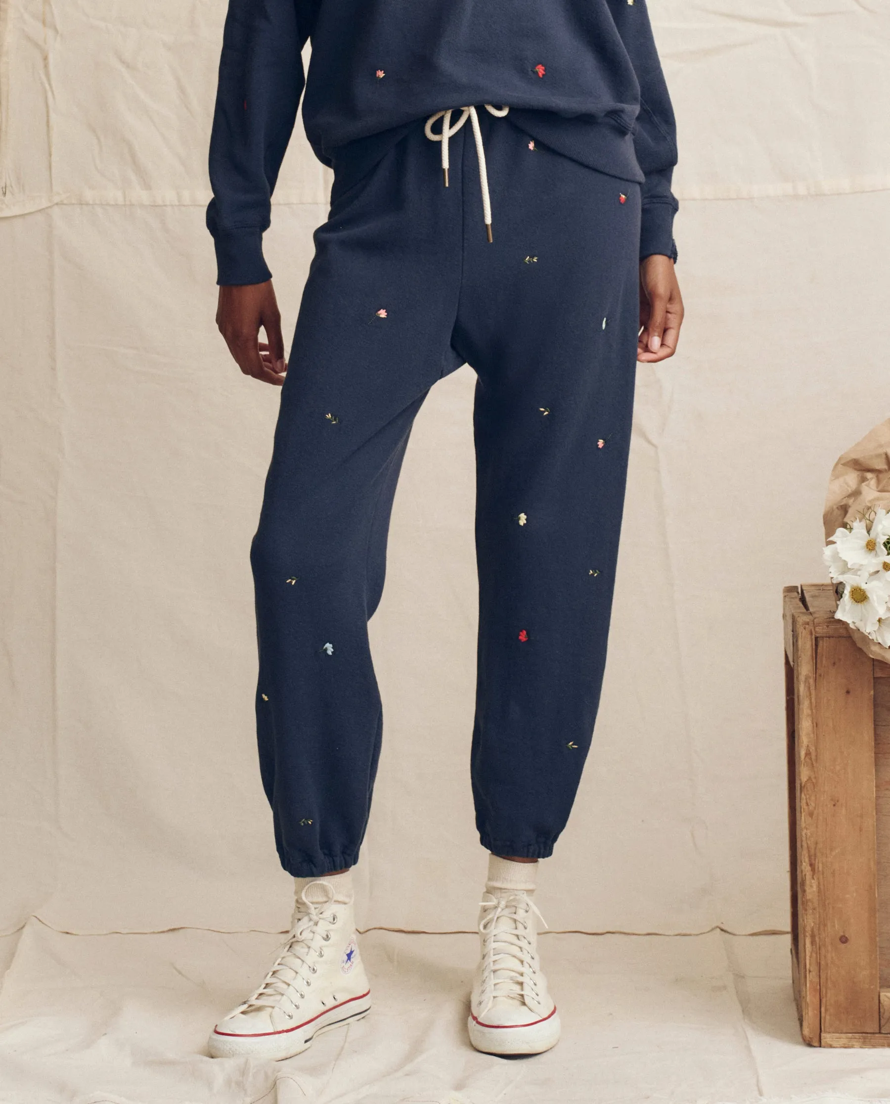 The Stadium Sweatpant. Embroidered -- Navy with Tossed Floral Embroidery sold by THE GREAT.