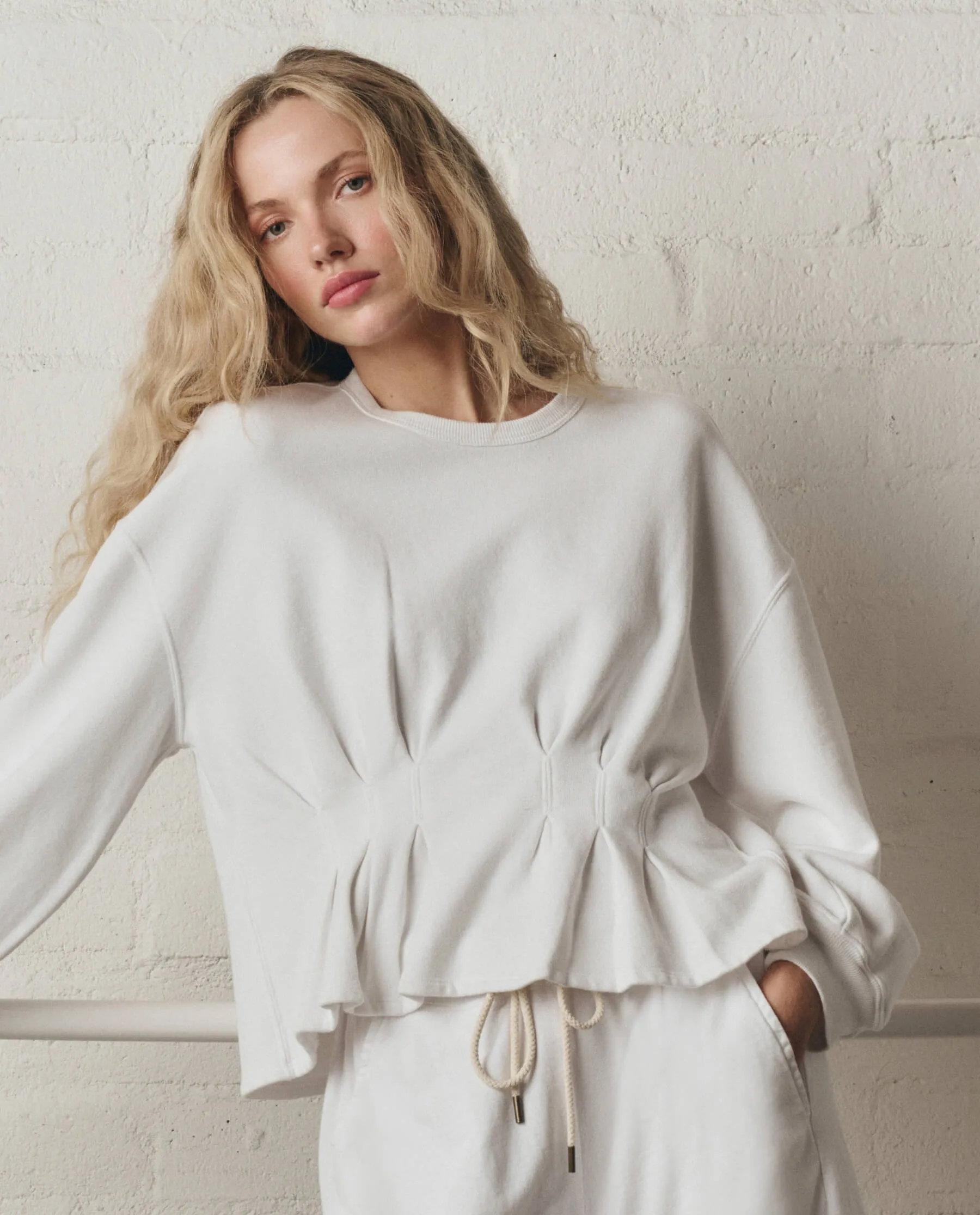The Slouchy Corset Sweatshirt. -- True White sold by THE GREAT.