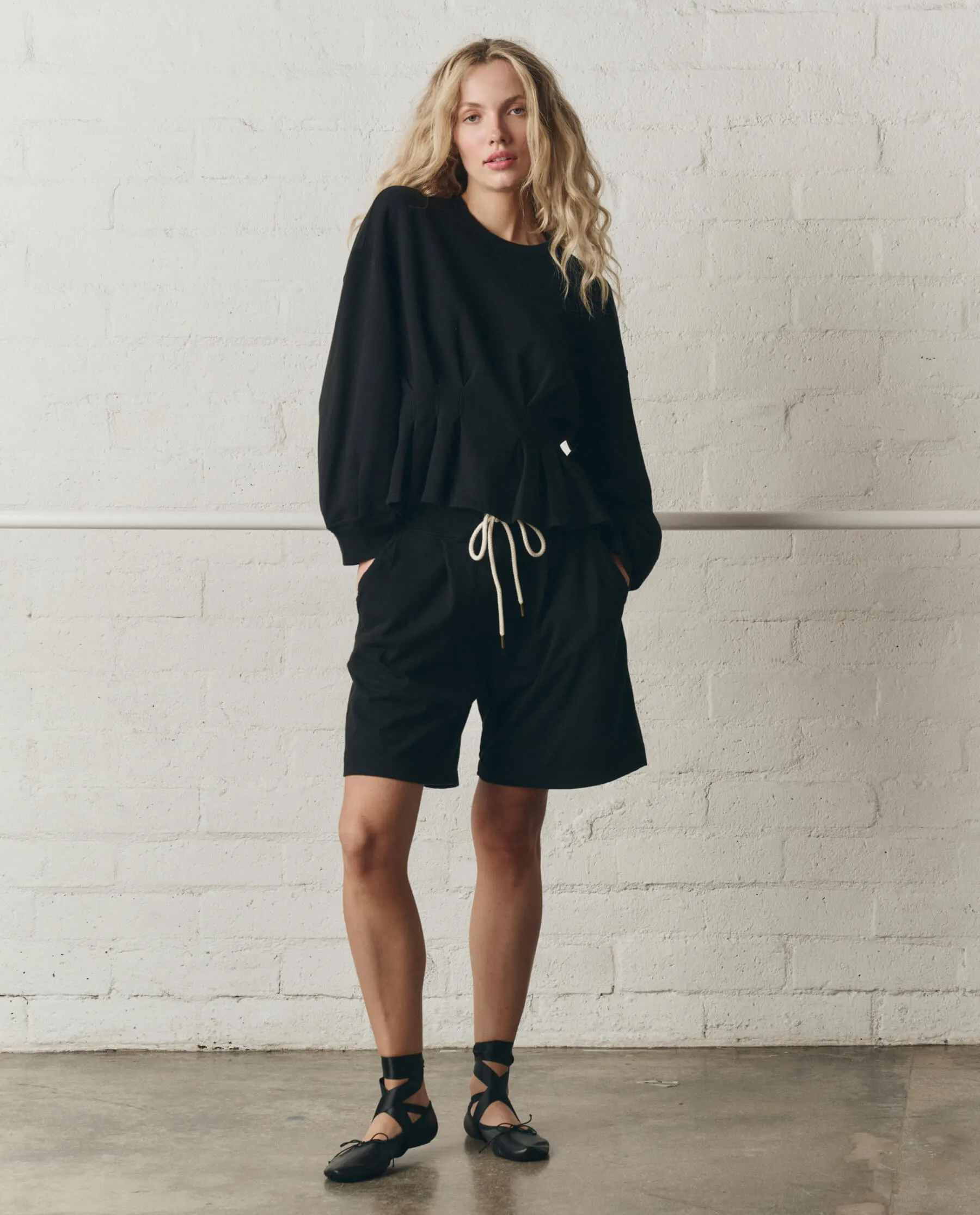 The Slouchy Corset Sweatshirt. -- True Black sold by THE GREAT.