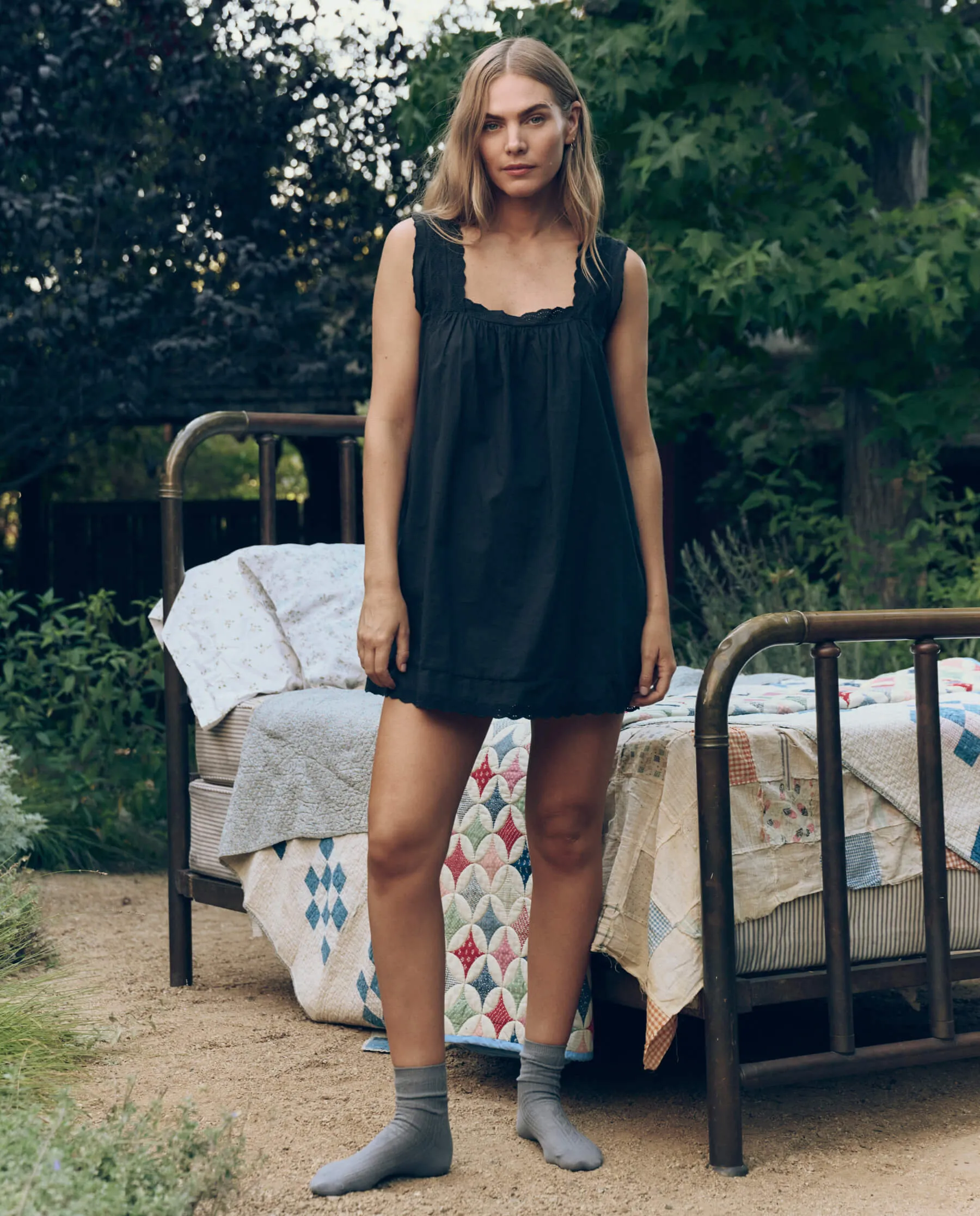 The Eyelet Mini Tank Dress. -- Black sold by THE GREAT.