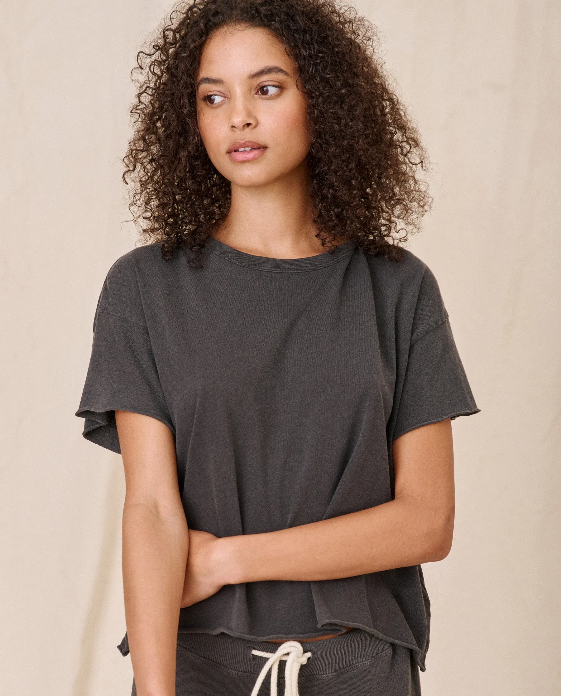 The Crop Tee. Solid -- Washed Black sold by THE GREAT.