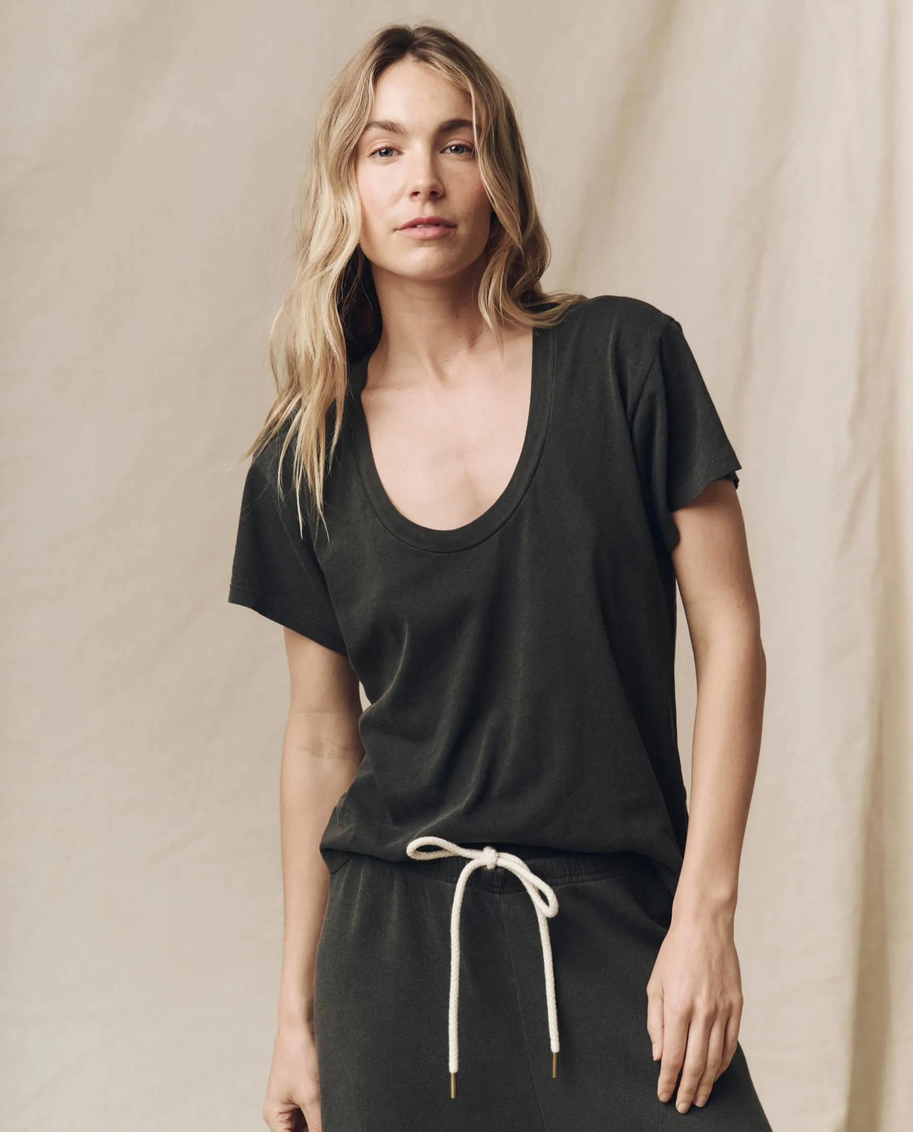 The Slim U-Neck Tee. Solid -- Washed Black sold by THE GREAT.