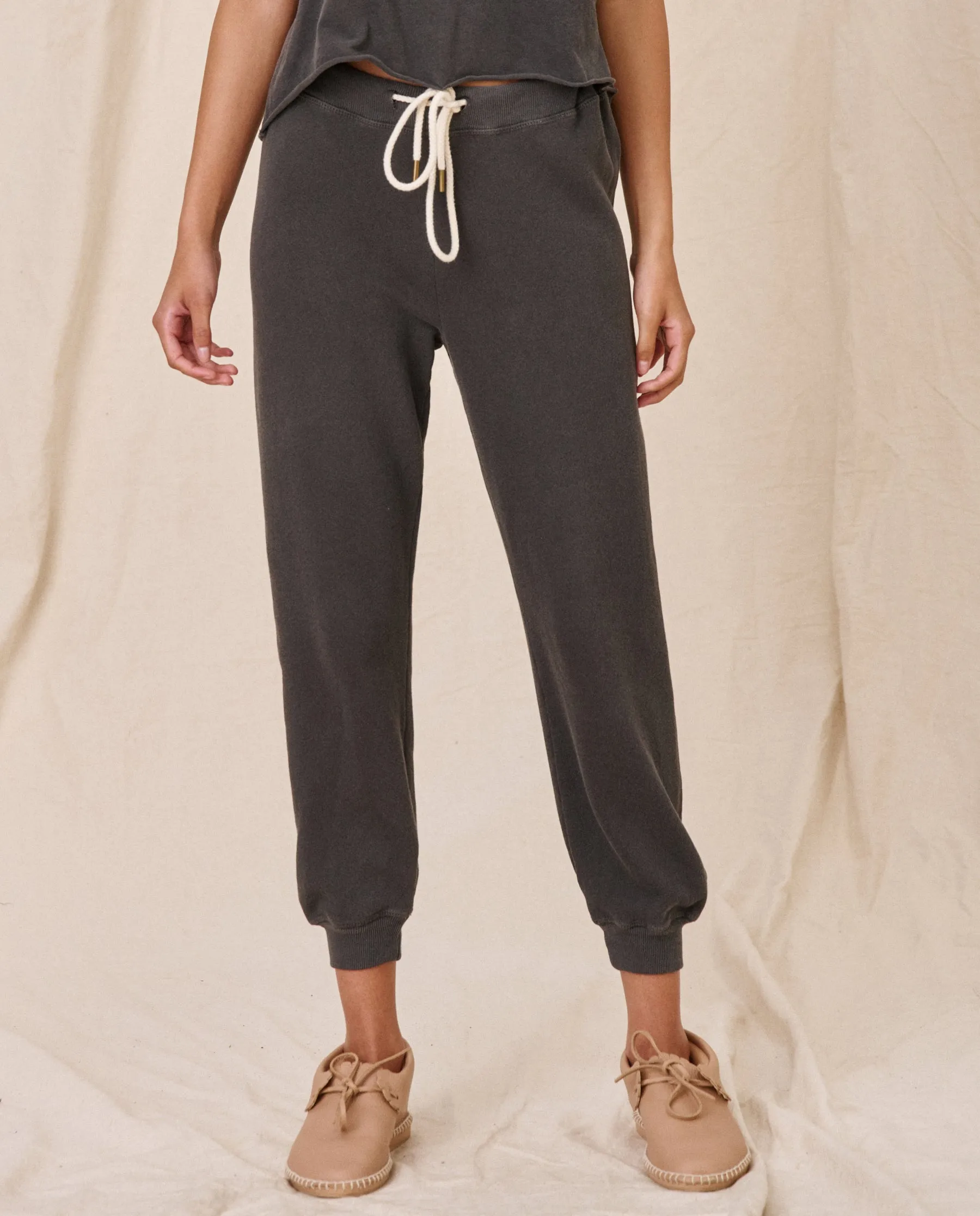 The Cropped Sweatpant. Solid -- Washed Black sold by THE GREAT.