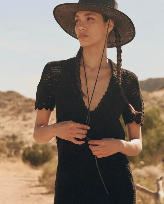 The Crochet Polo Dress. -- Black sold by THE GREAT.