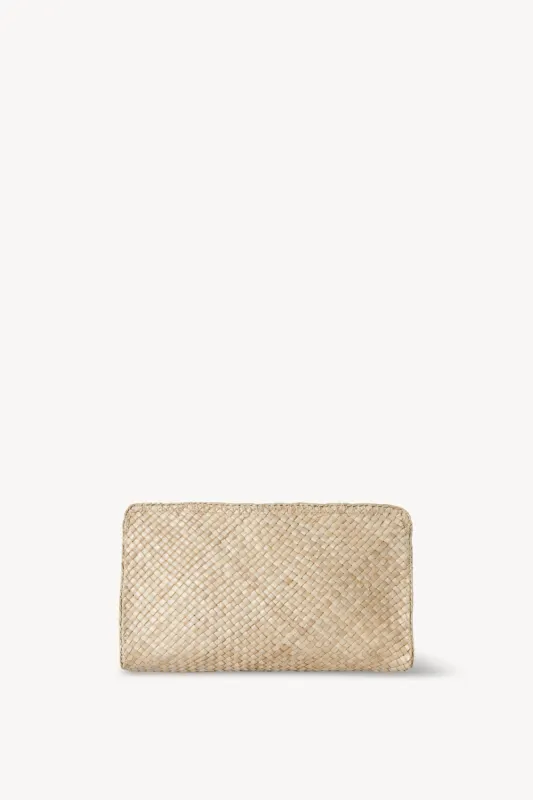 Remi Clutch in Straw sold by The Row