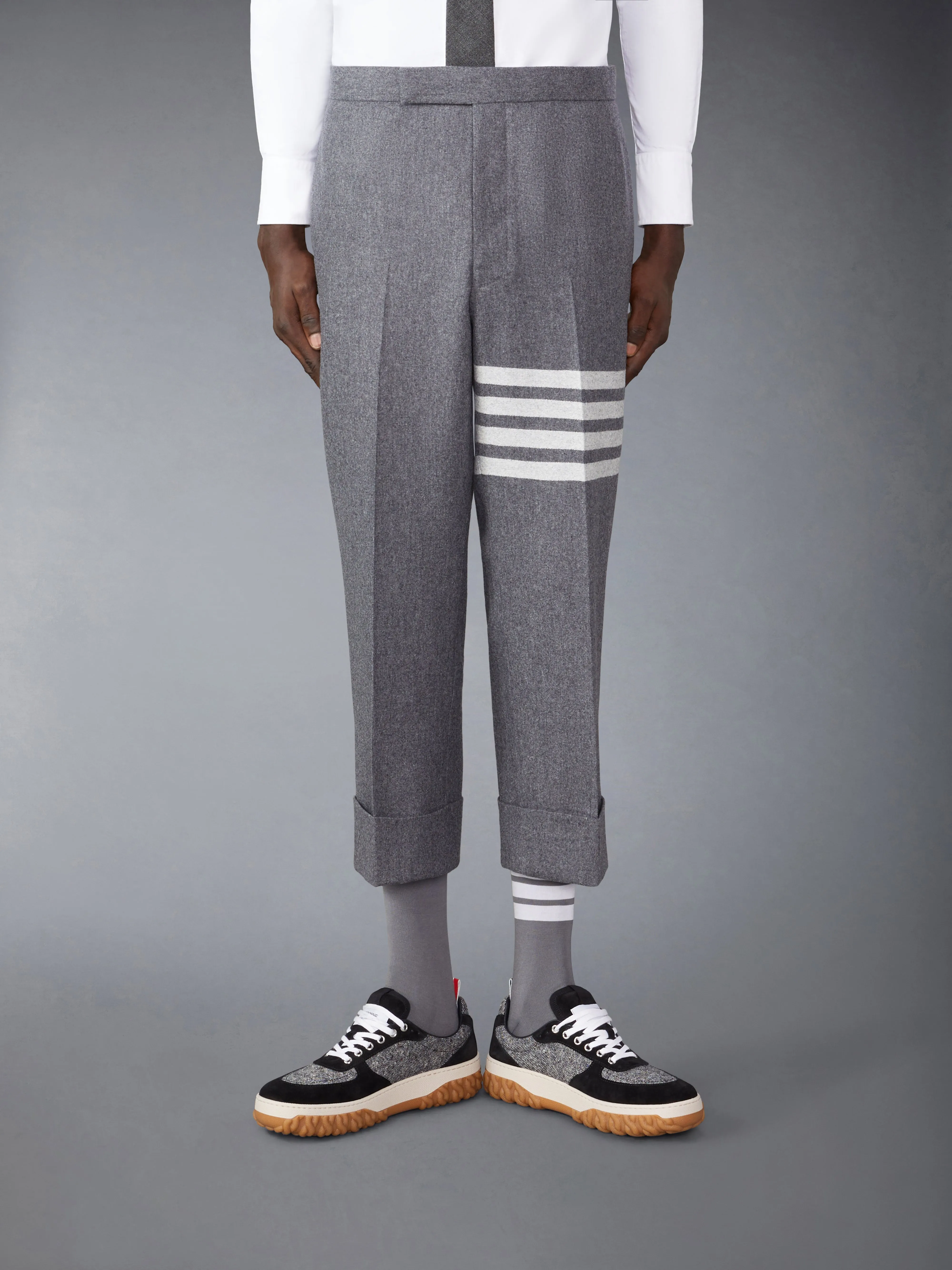FLANNEL 4-BAR LOW RISE BACKSTRAP TROUSERS sold by Thom Browne