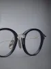 ACETATE AND TITANIUM ROUND EYEGLASSES sold by Thom Browne