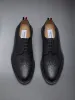 PEBBLE GRAIN RUBBER SOLE LONGWING BROGUE sold by Thom Browne