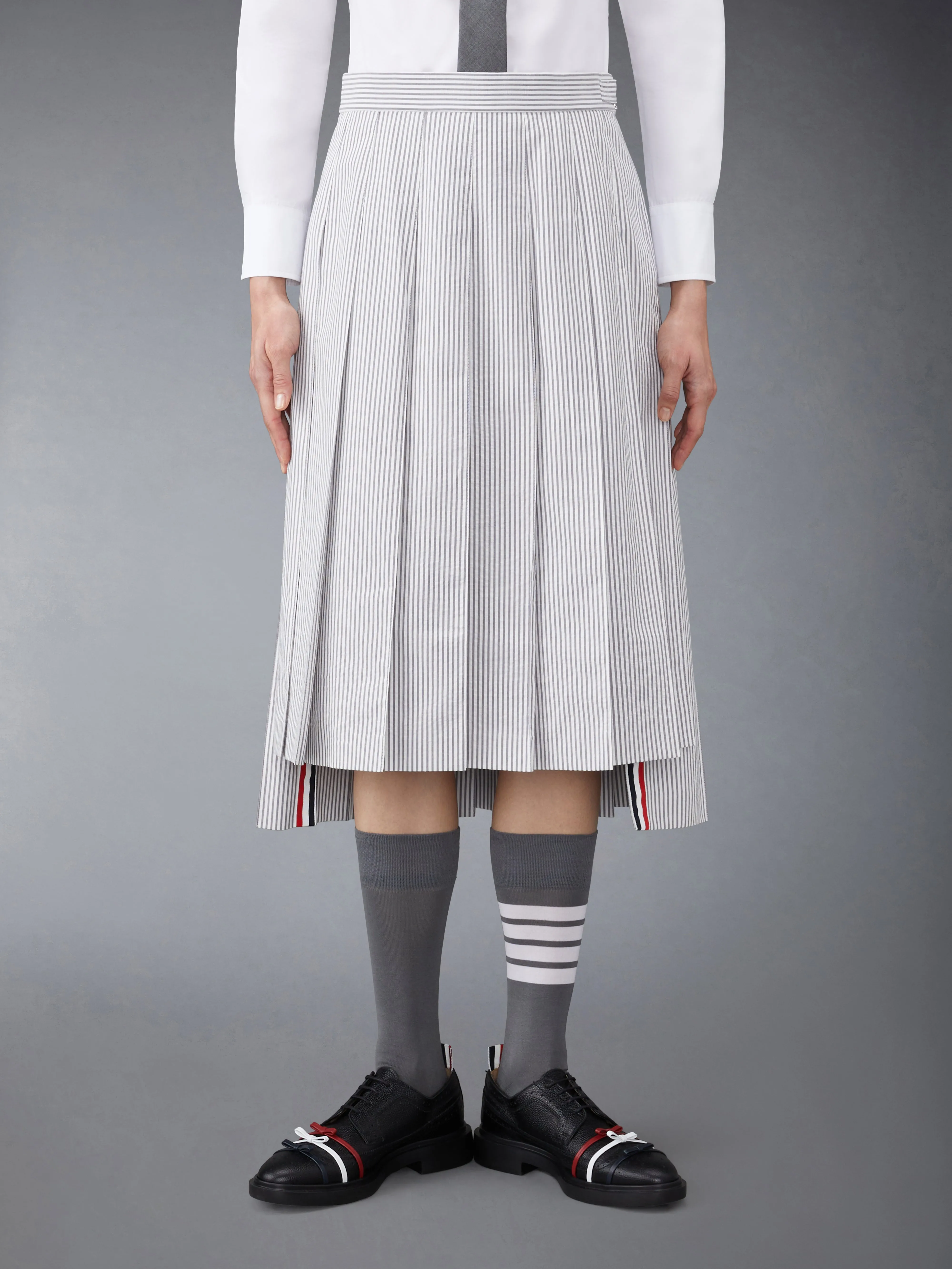 SEERSUCKER MIDI PLEATED SKIRT sold by Thom Browne