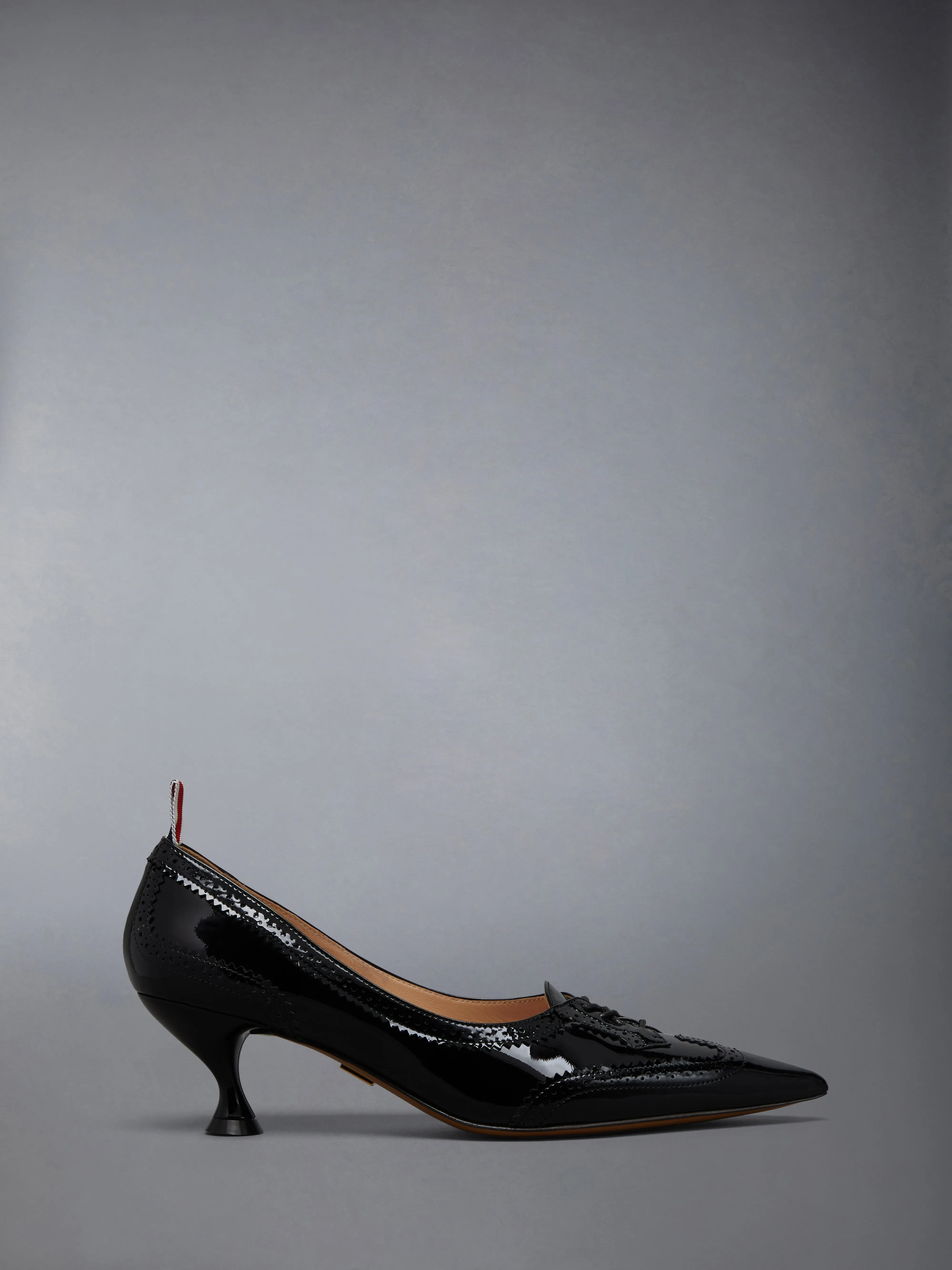 SOFT PATENT LEATHER WINGTIP 50MM CURVED HEEL PUMP sold by Thom Browne