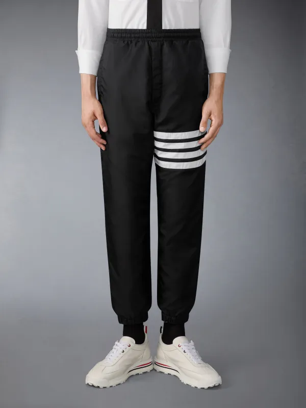 SHINY RIPSTOP 4-BAR TRACK PANTS sold by Thom Browne