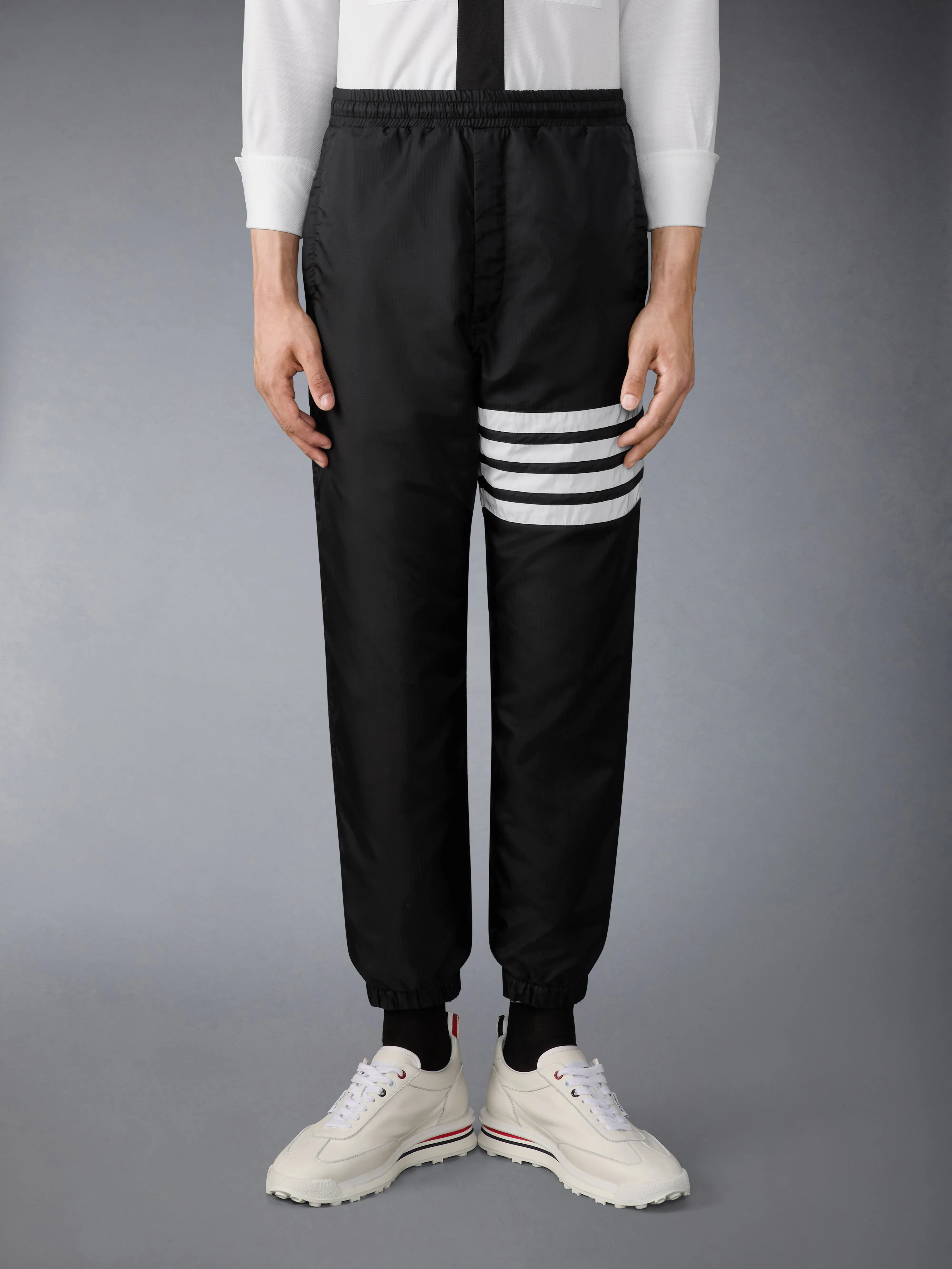 SHINY RIPSTOP 4-BAR TRACK PANTS sold by Thom Browne