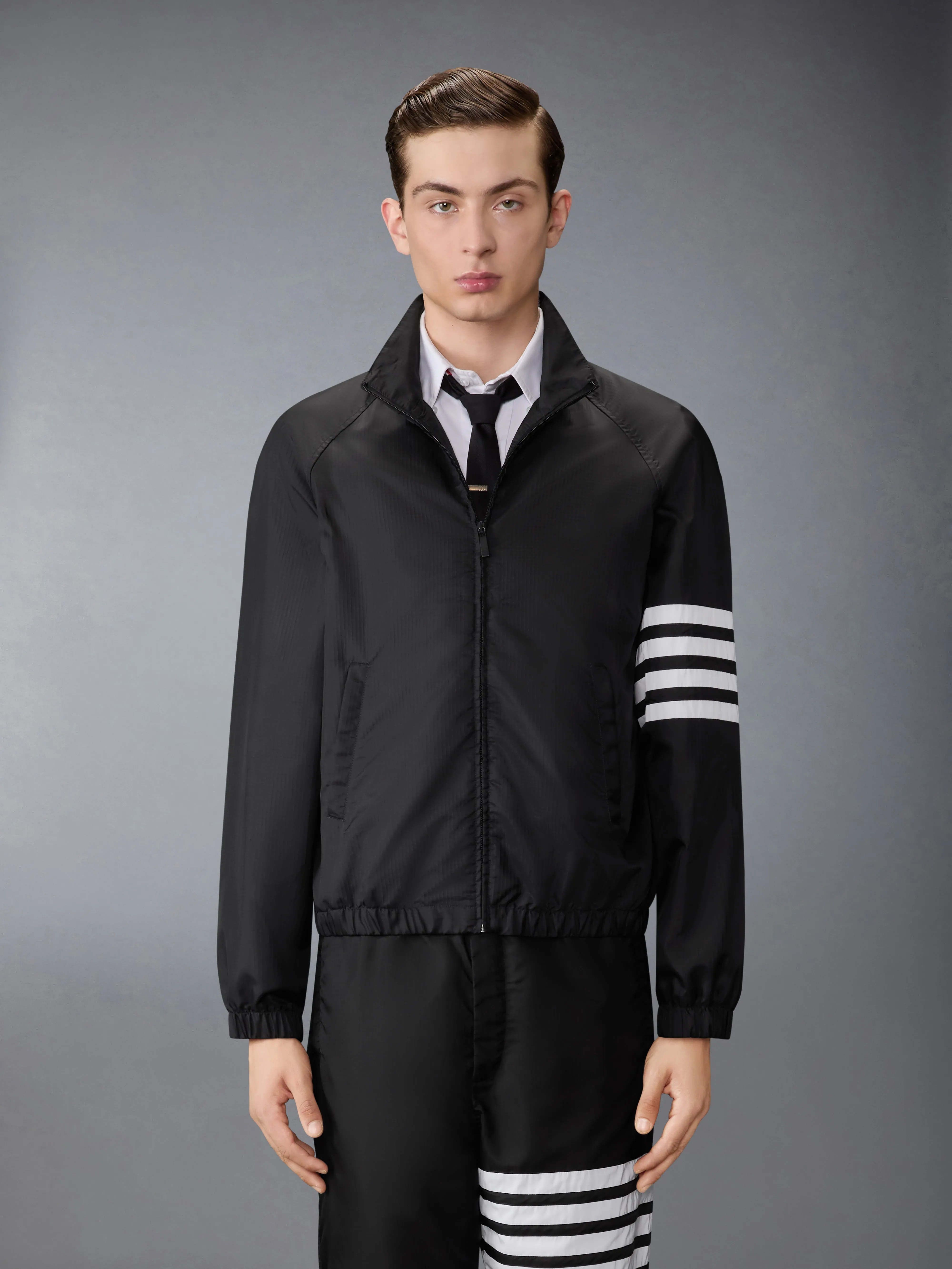 SHINY RIPSTOP RAGLAN 4-BAR TRACK JACKET sold by Thom Browne