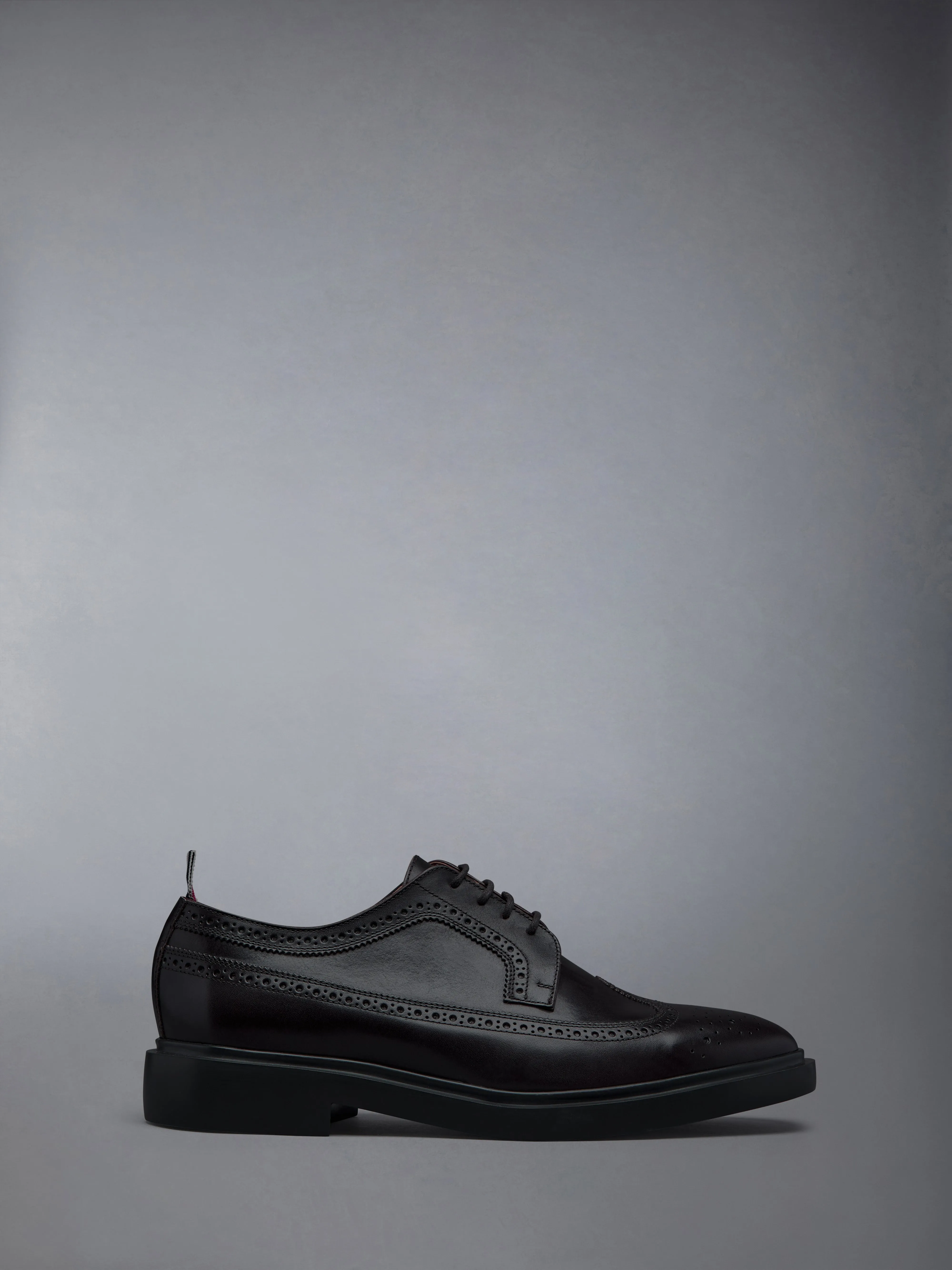 BOX CALF LONGWING RUBBER SOLE BROGUES sold by Thom Browne