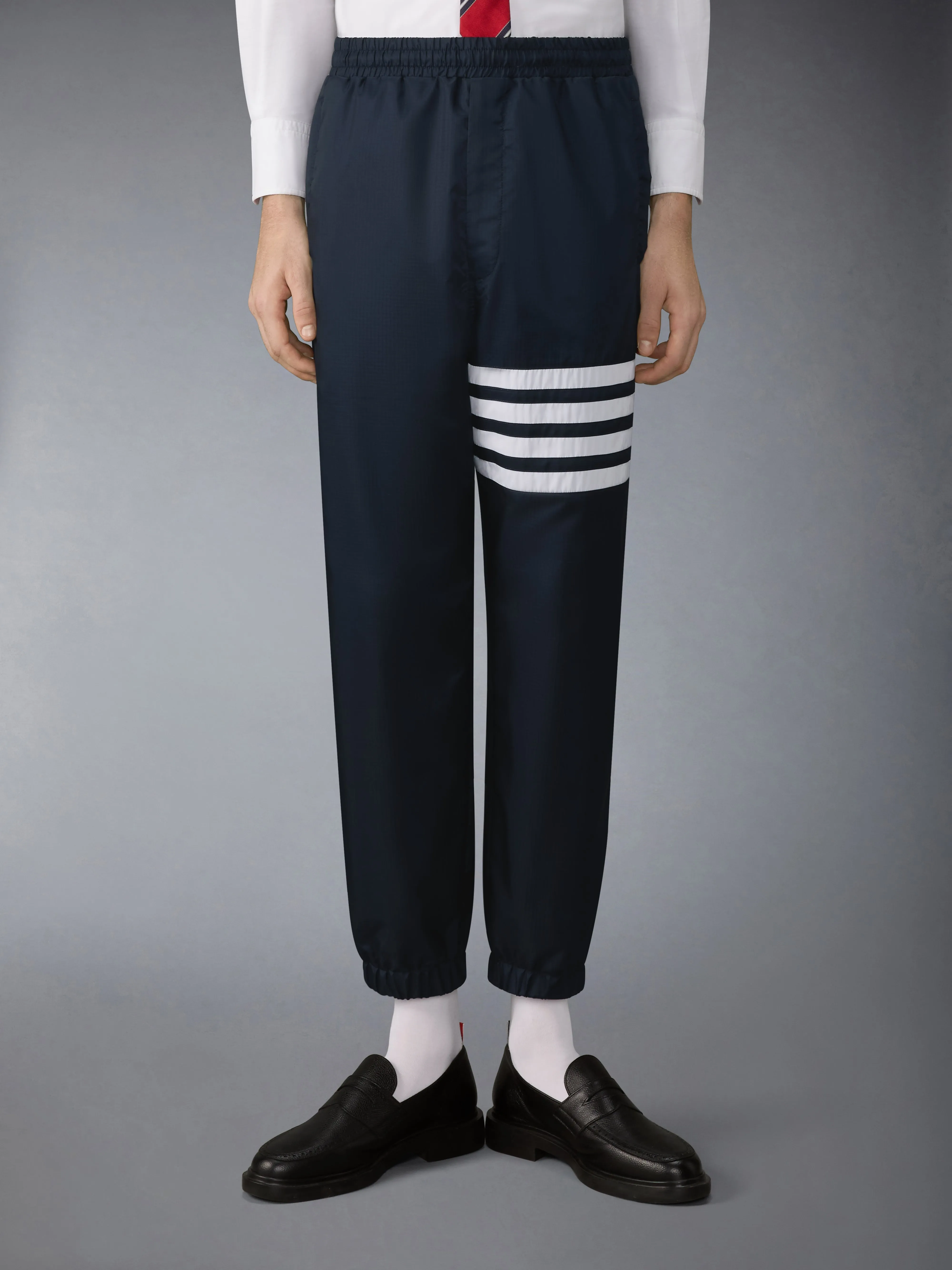 SHINY RIPSTOP 4-BAR TRACK PANTS sold by Thom Browne