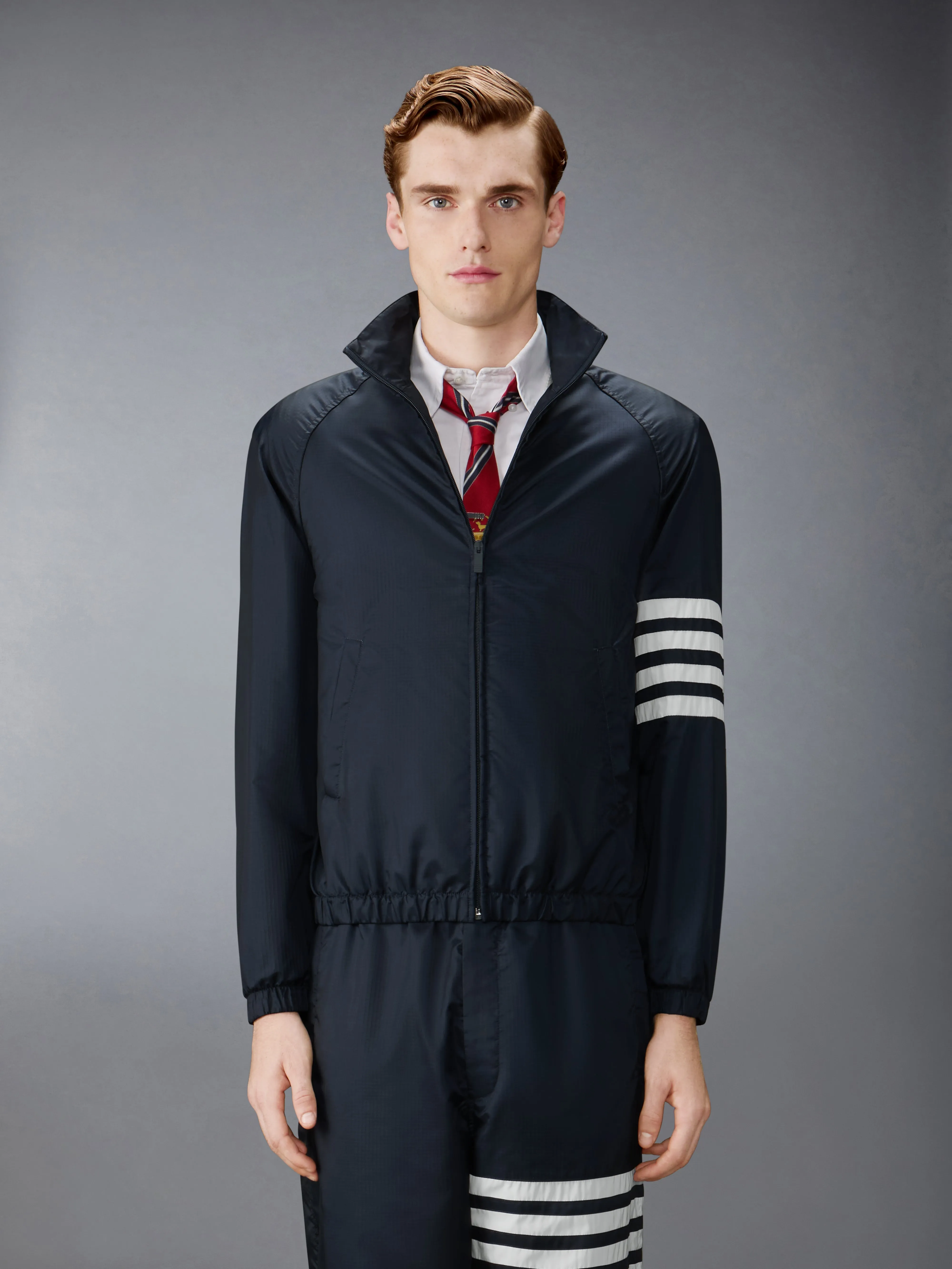 SHINY RIPSTOP RAGLAN 4-BAR TRACK JACKET sold by Thom Browne