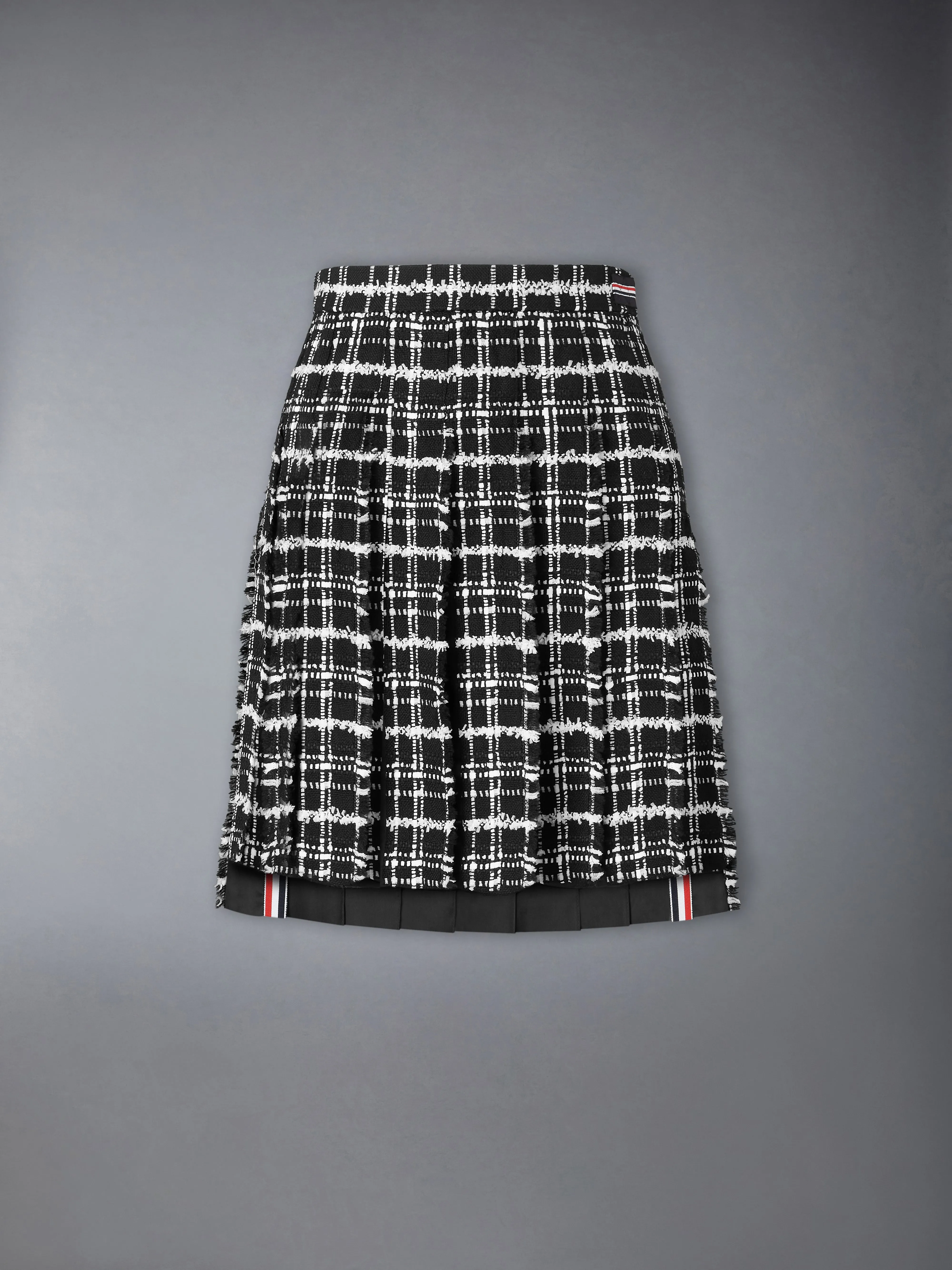 RIBBON TWEED PLEATED SKIRT WITH FRAY EDGE sold by Thom Browne