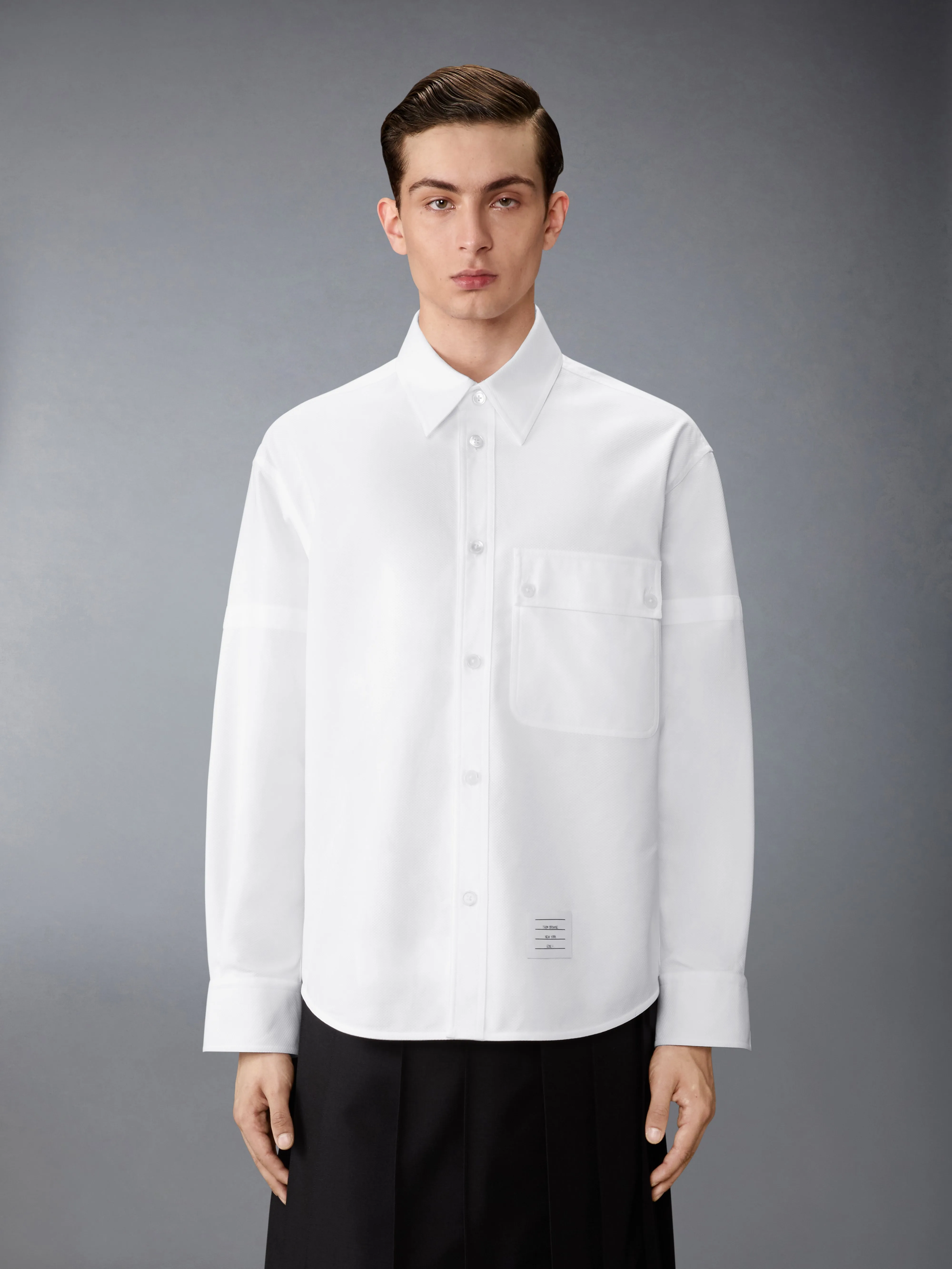 PIQUE DOUBLE NEEDLE ARMBAND OVERSIZED SHIRT sold by Thom Browne