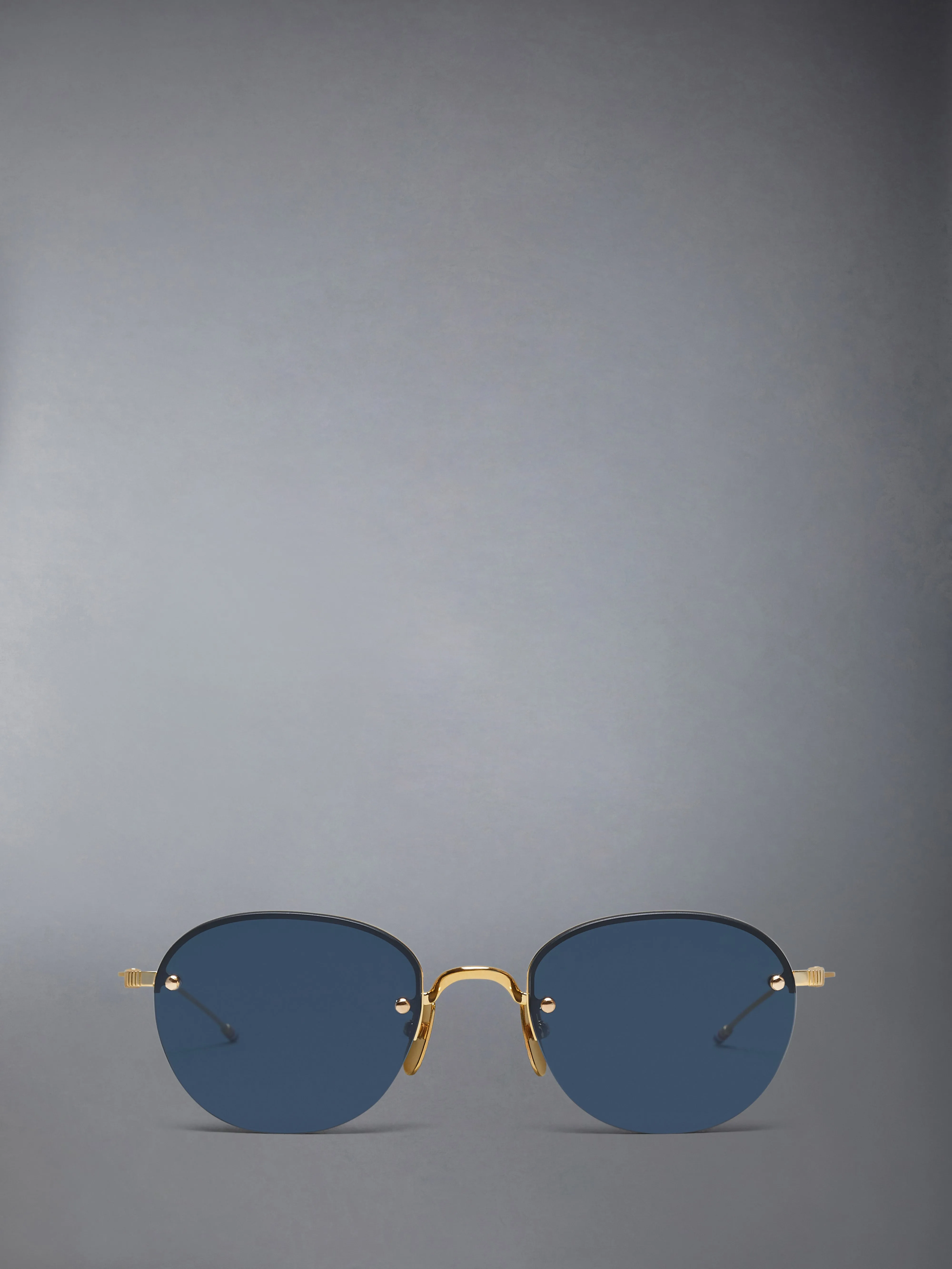 TITANIUM SEMI RIMLESS OVAL SUNGLASSES sold by Thom Browne