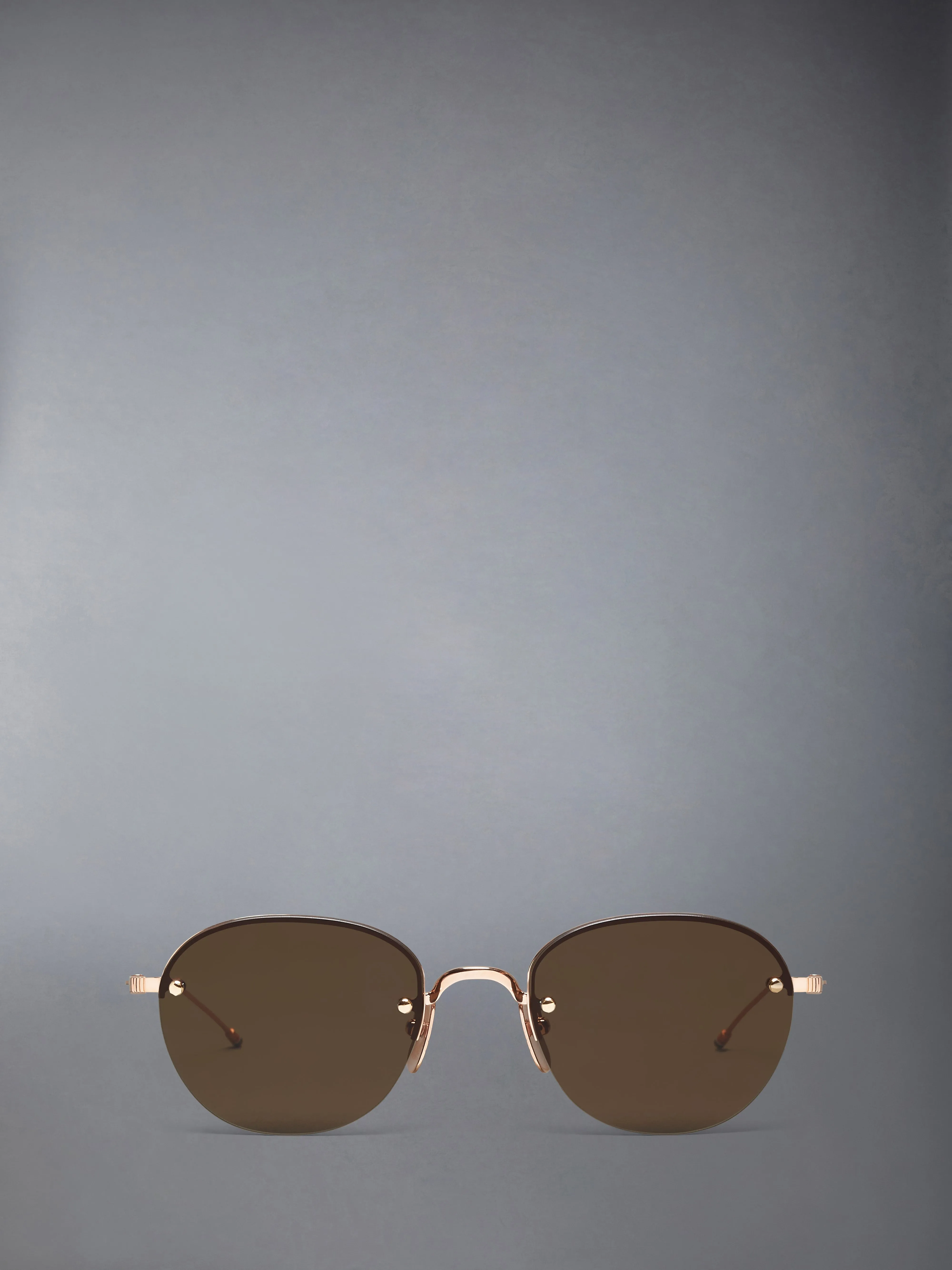 TITANIUM SEMI RIMLESS OVAL SUNGLASSES sold by Thom Browne