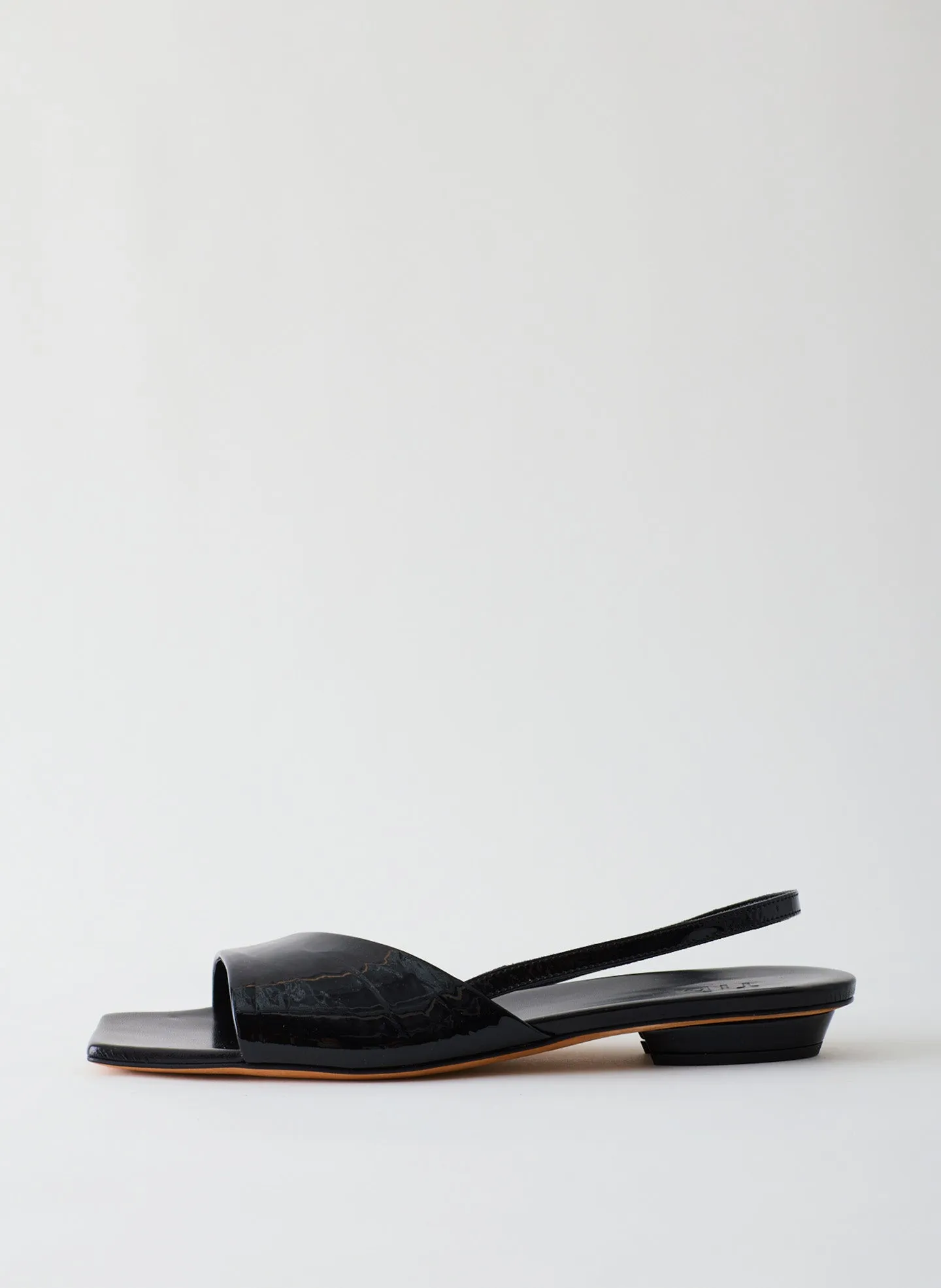 Avi Crinkle Patent Asymmetric Flat sold by Tibi