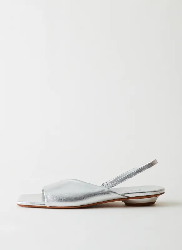 Avi Metallic Asymmetric Flat sold by Tibi