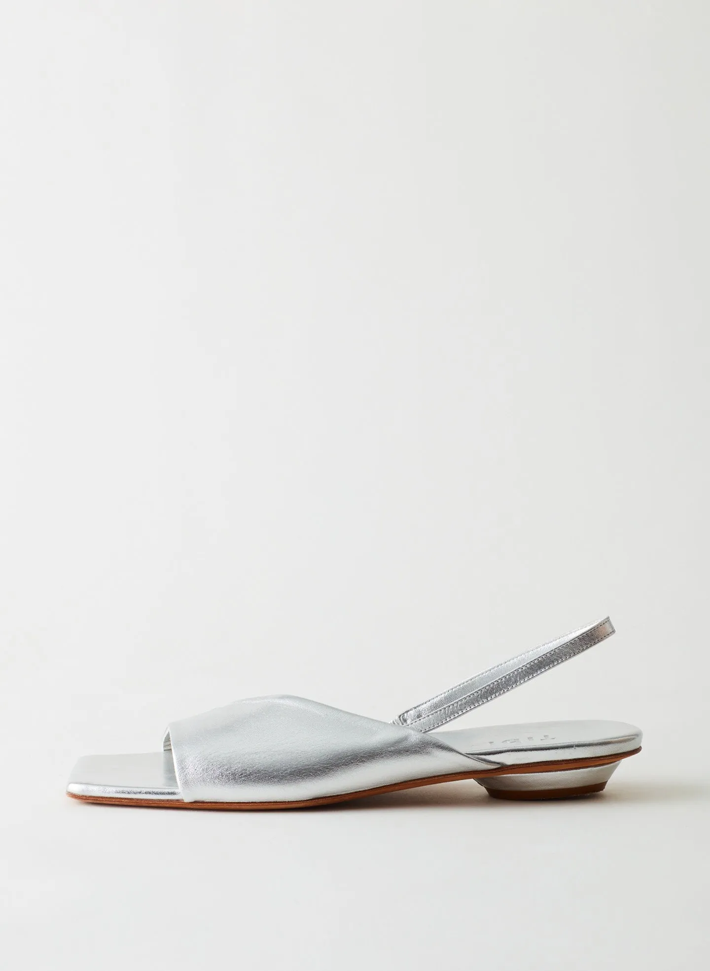 Avi Metallic Asymmetric Flat sold by Tibi