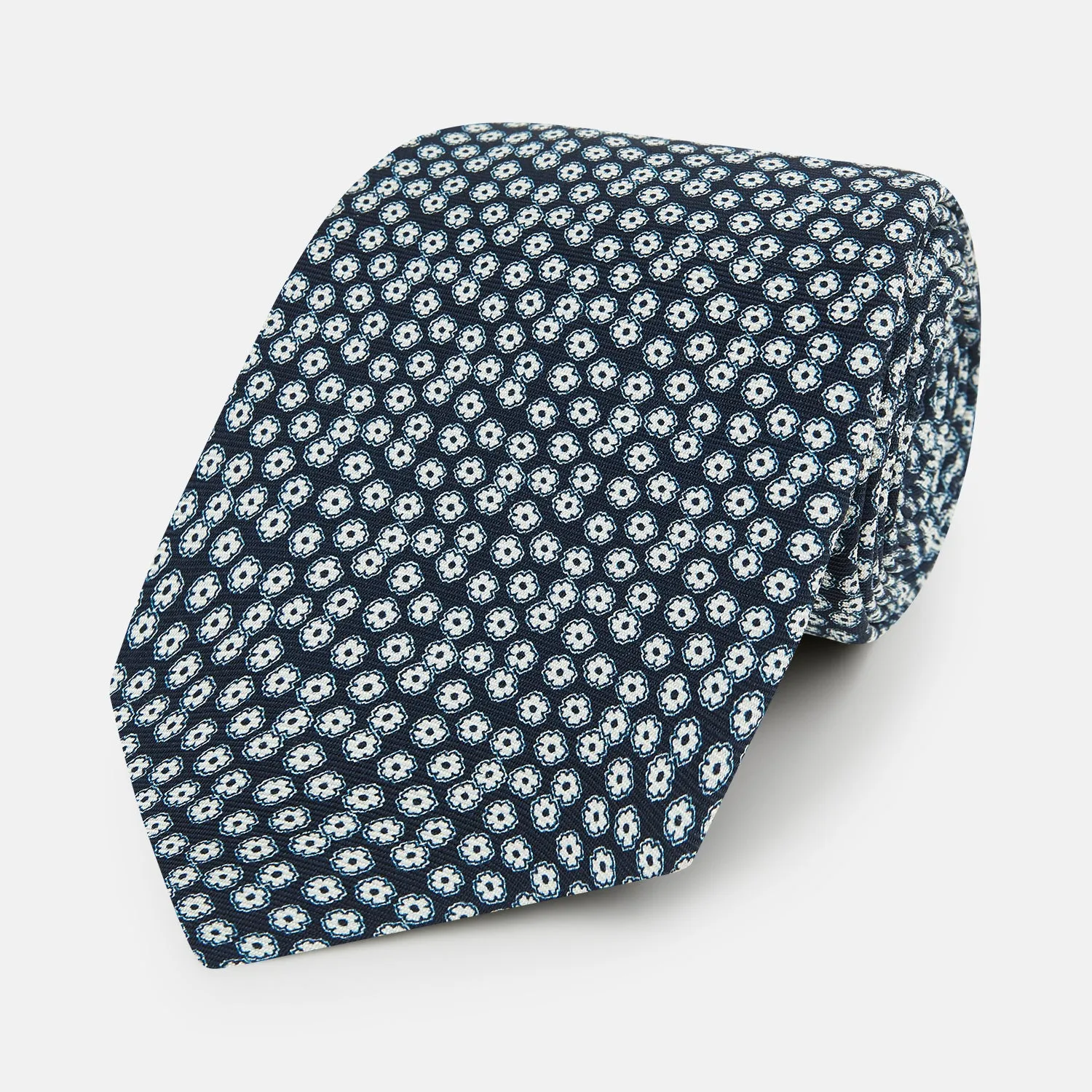 Navy Flower Patterned Printed Silk Tie sold by Turnbull & Asser