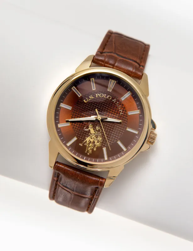 MEN'S BROWN STRAP WATCH WITH GOLDTONE CASE sold by U.S. Polo Assn.