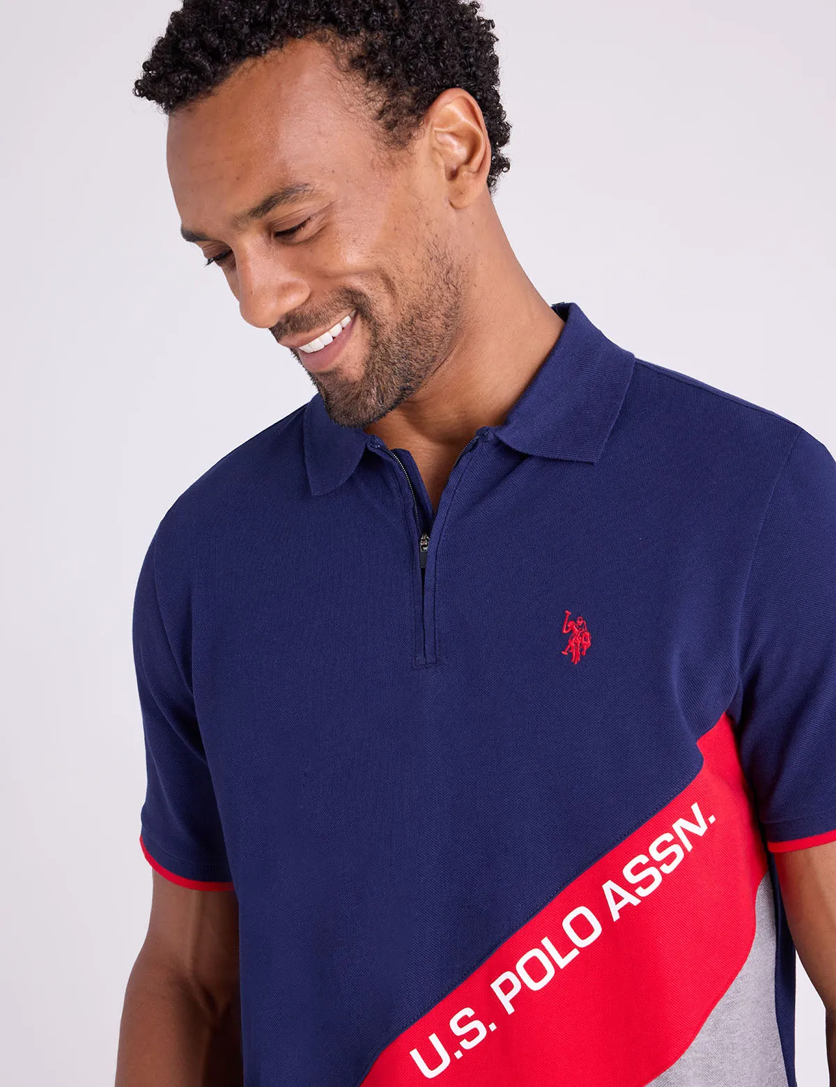 PIQUE COLOR BLOCK ZIPPER POLO SHIRT sold by U.S. Polo Assn.