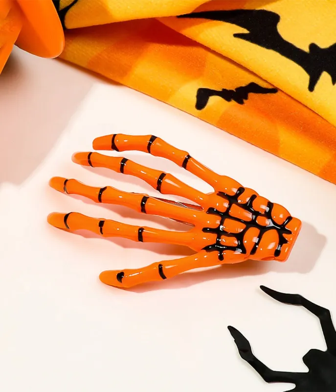 Orange Skeleton Hand Hair Clip sold by Unique Vintage