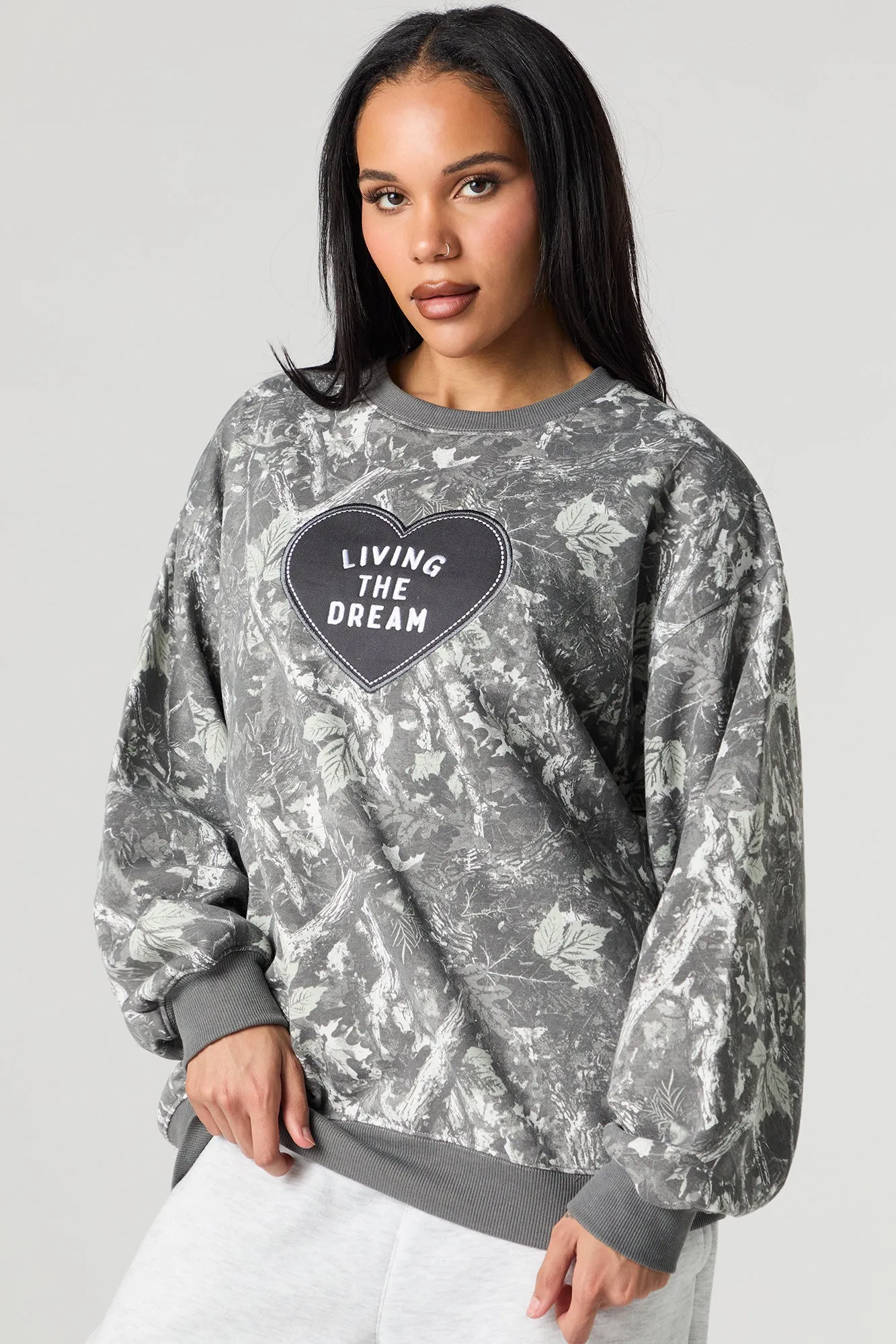Living The Dream Embroidered Fleece Camo Sweatshirt sold by Urban Planet