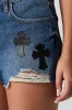 Short en denim d'aspect usé avec appliqué de croix sold by Urban Planet