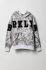 Haut à capuchon en molleton avec empiècement à motif camouflage pour enfant sold by Urban Planet