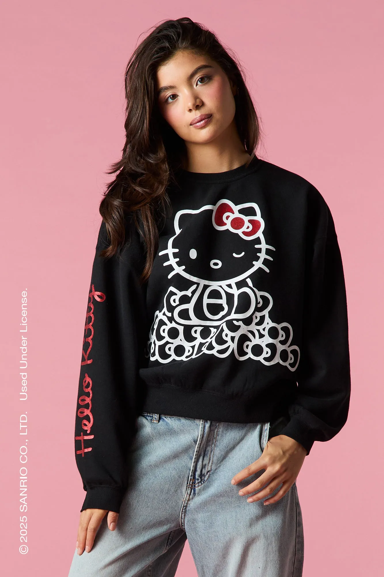 Hello Kitty® Glitter Graphic Fleece Sweatshirt sold by Urban Planet