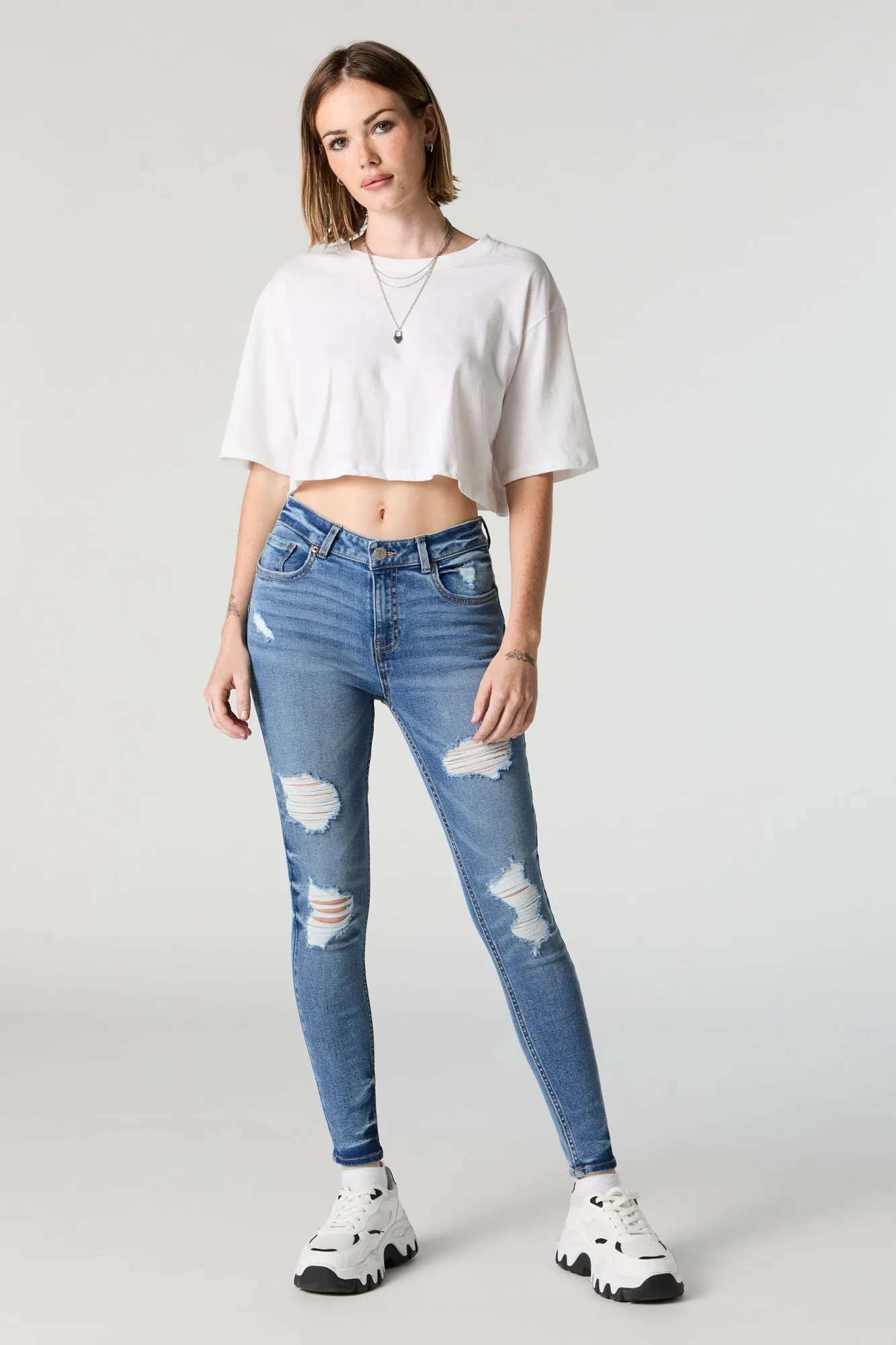 Rio Medium Wash Mid Rise Distressed Skinny Jean sold by Urban Planet