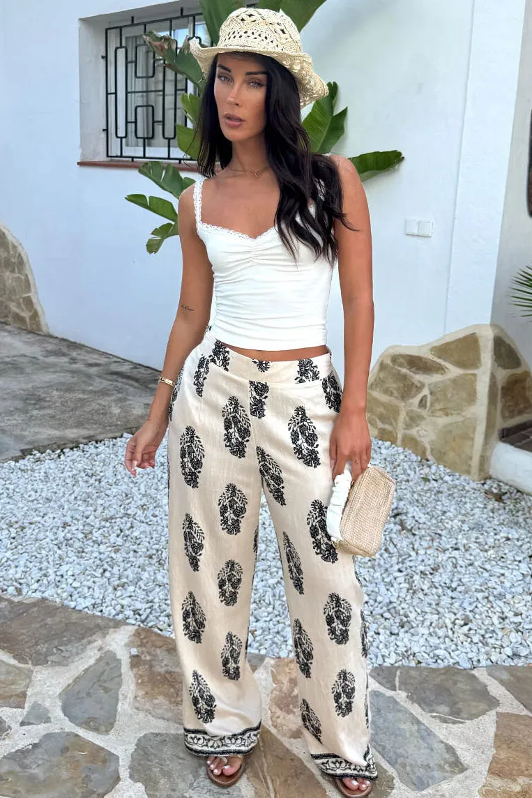 Holly Cream Border Print Wide Leg Trousers sold by Vavavoom