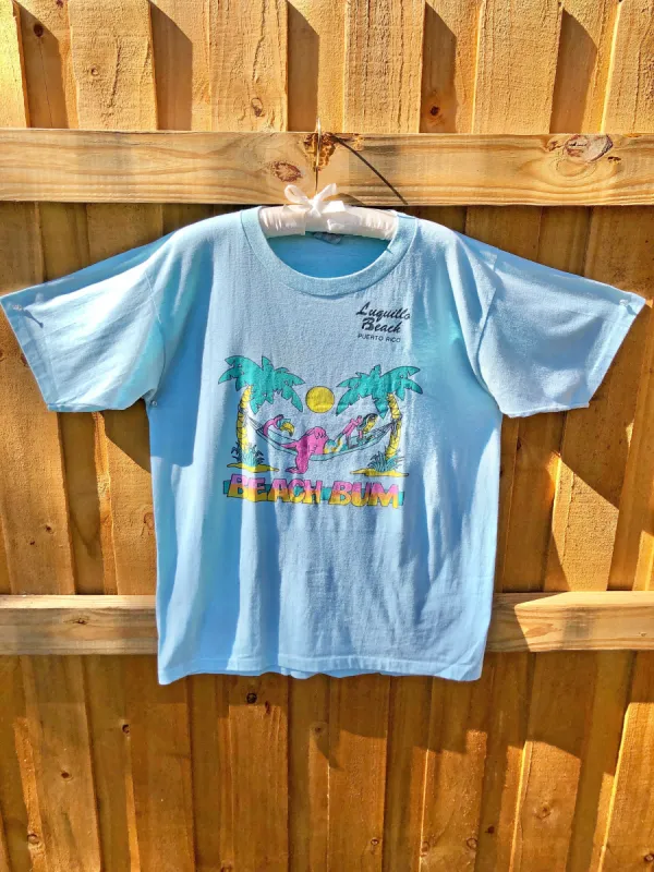 VINTAGE: Baby Blue Beach Bum T-Shirt sold by Vanessa Mooney