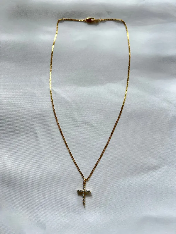 The Tiny Cross Necklace sold by Vanessa Mooney