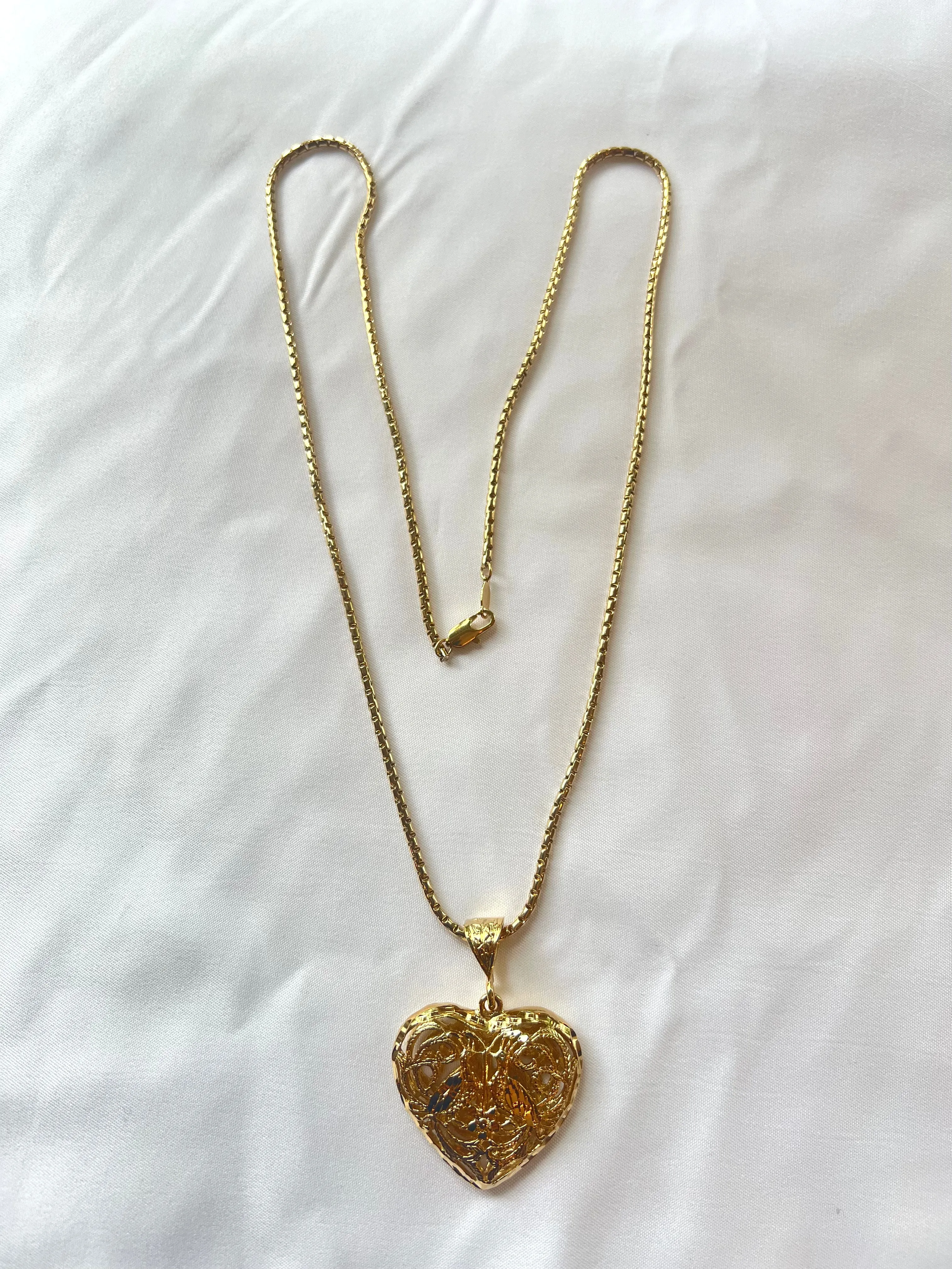 The Bird & Heart Necklace sold by Vanessa Mooney