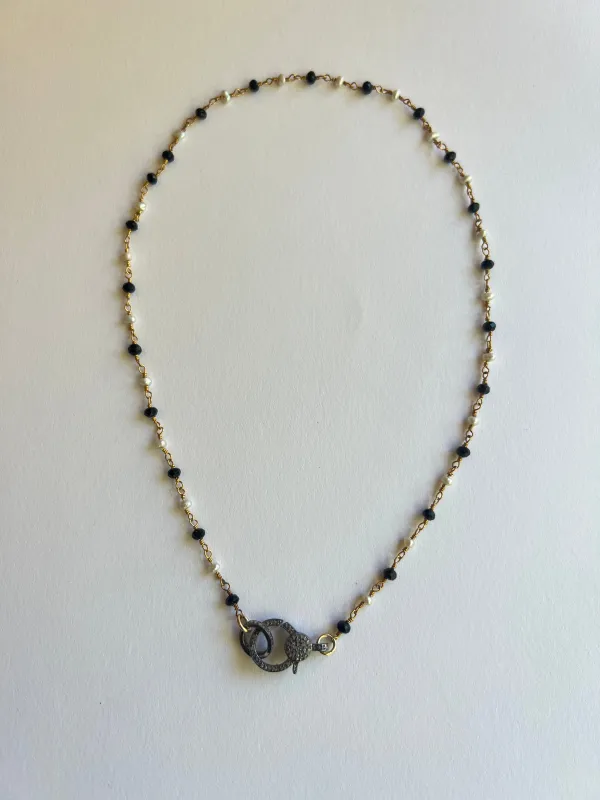 The Pearl & Oynx Small Diamond Clasp Necklace sold by Vanessa Mooney