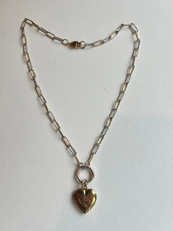 The Gold & Silver Heart Locket Necklace sold by Vanessa Mooney