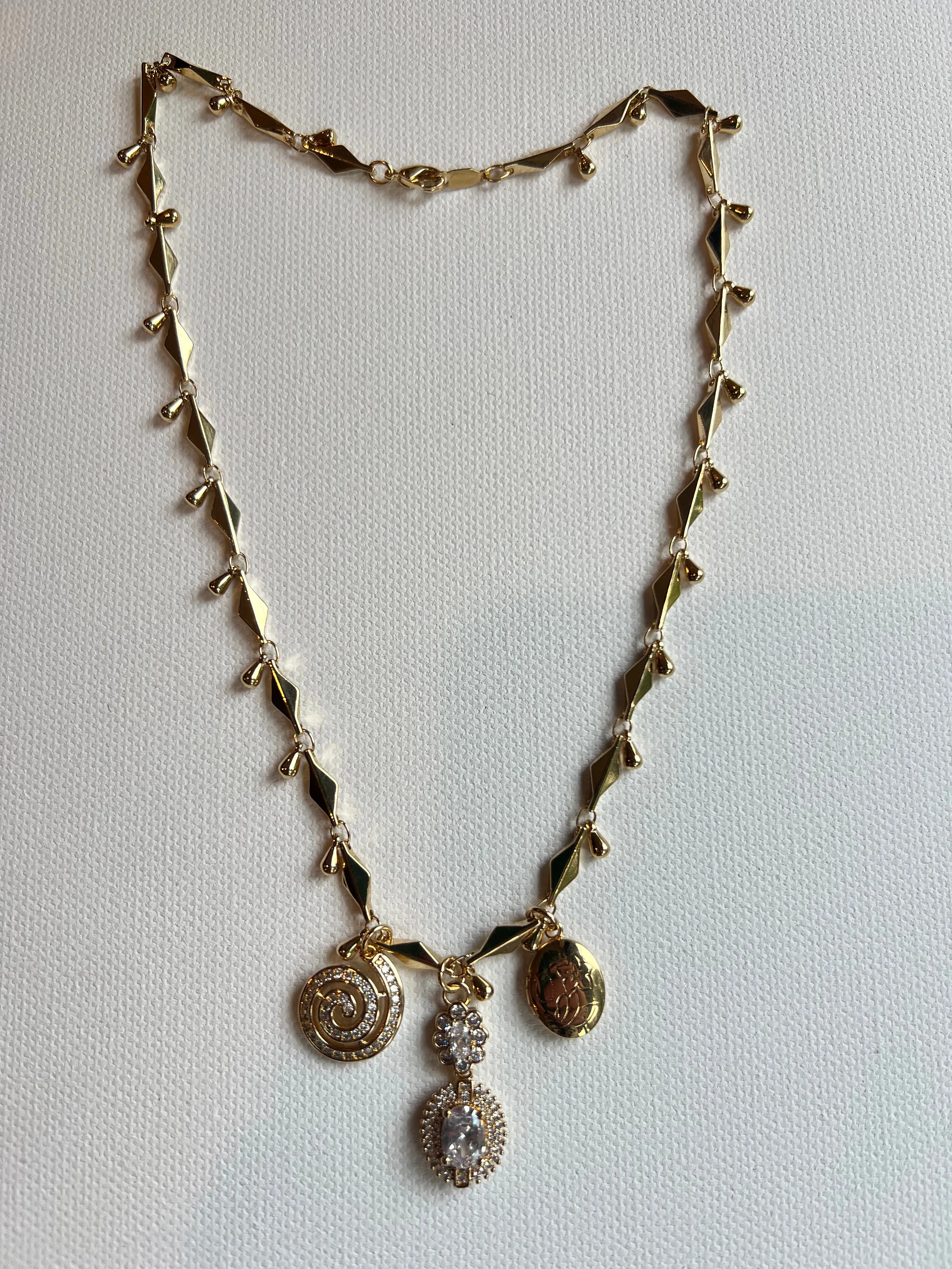The Crystal & Gold Charm Necklace sold by Vanessa Mooney