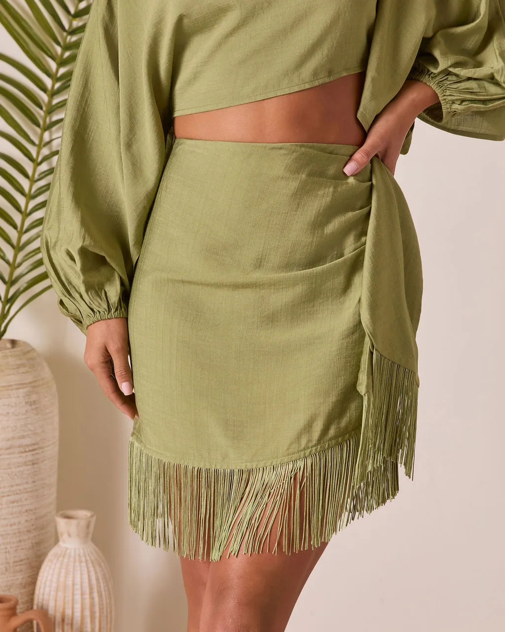 Caelia Wrap Fringe Mini Skirt sold by Vici
